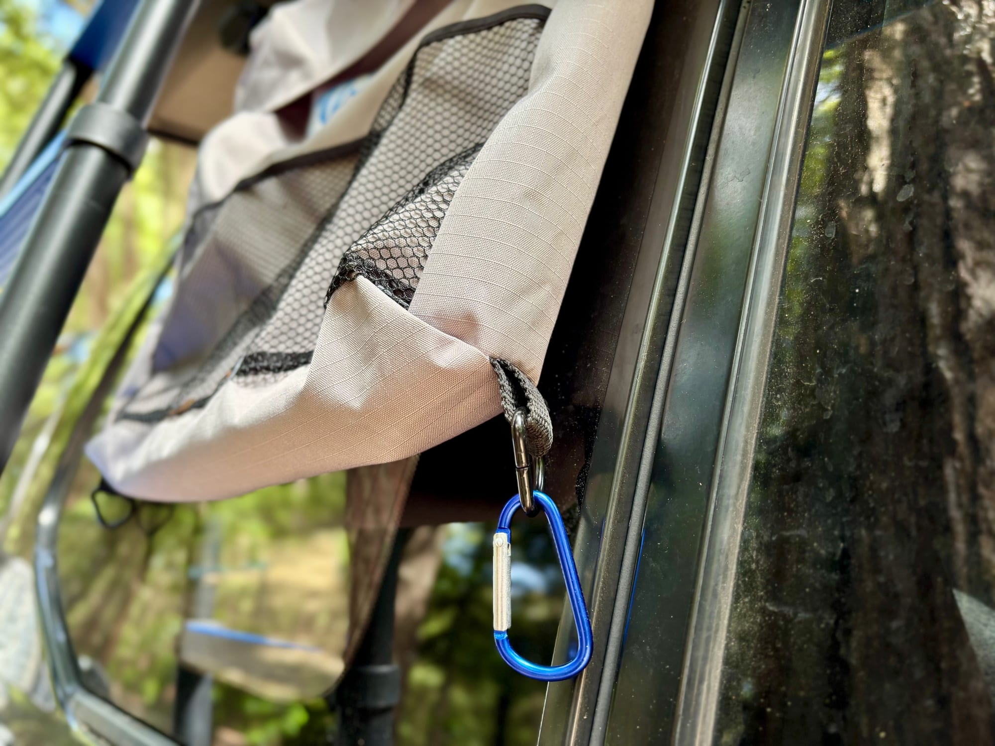 A blue carabiner clipped to the bottom corner of the Kings storage bag