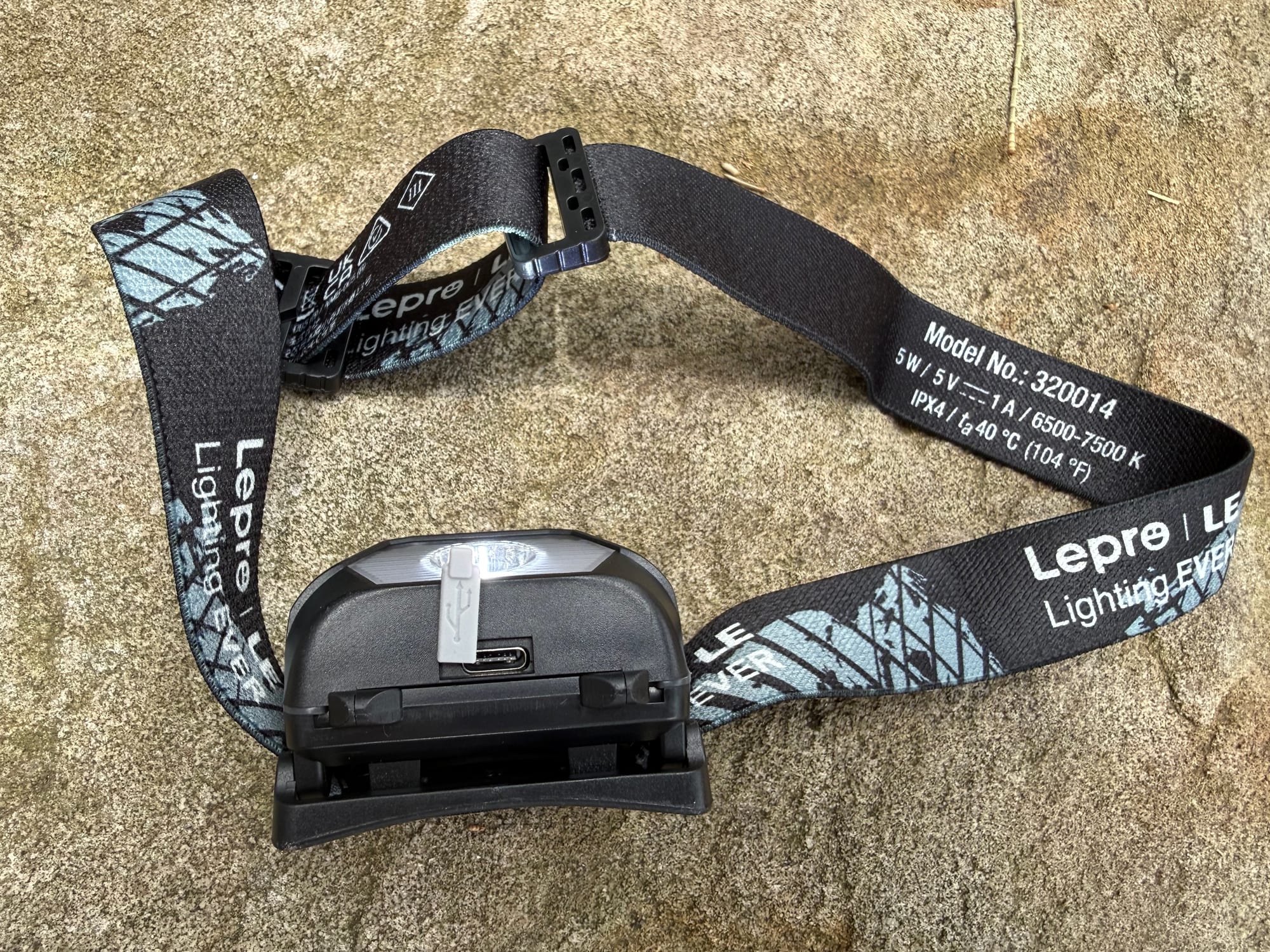 The back of the Lepro 320014 with its charging port, and the model number printed on the strap