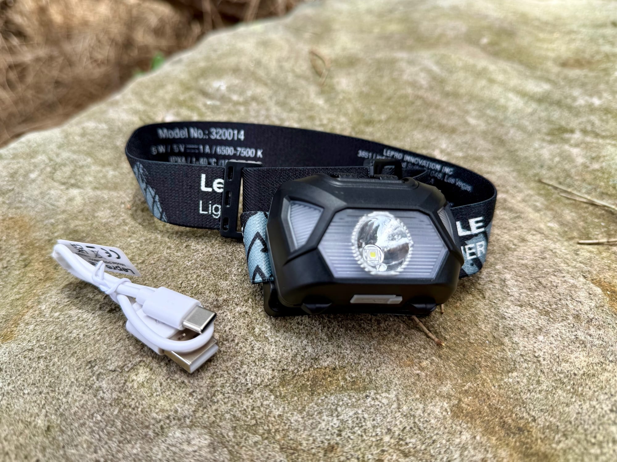 The Lepro 320014 headlamp with its white USB charging cable