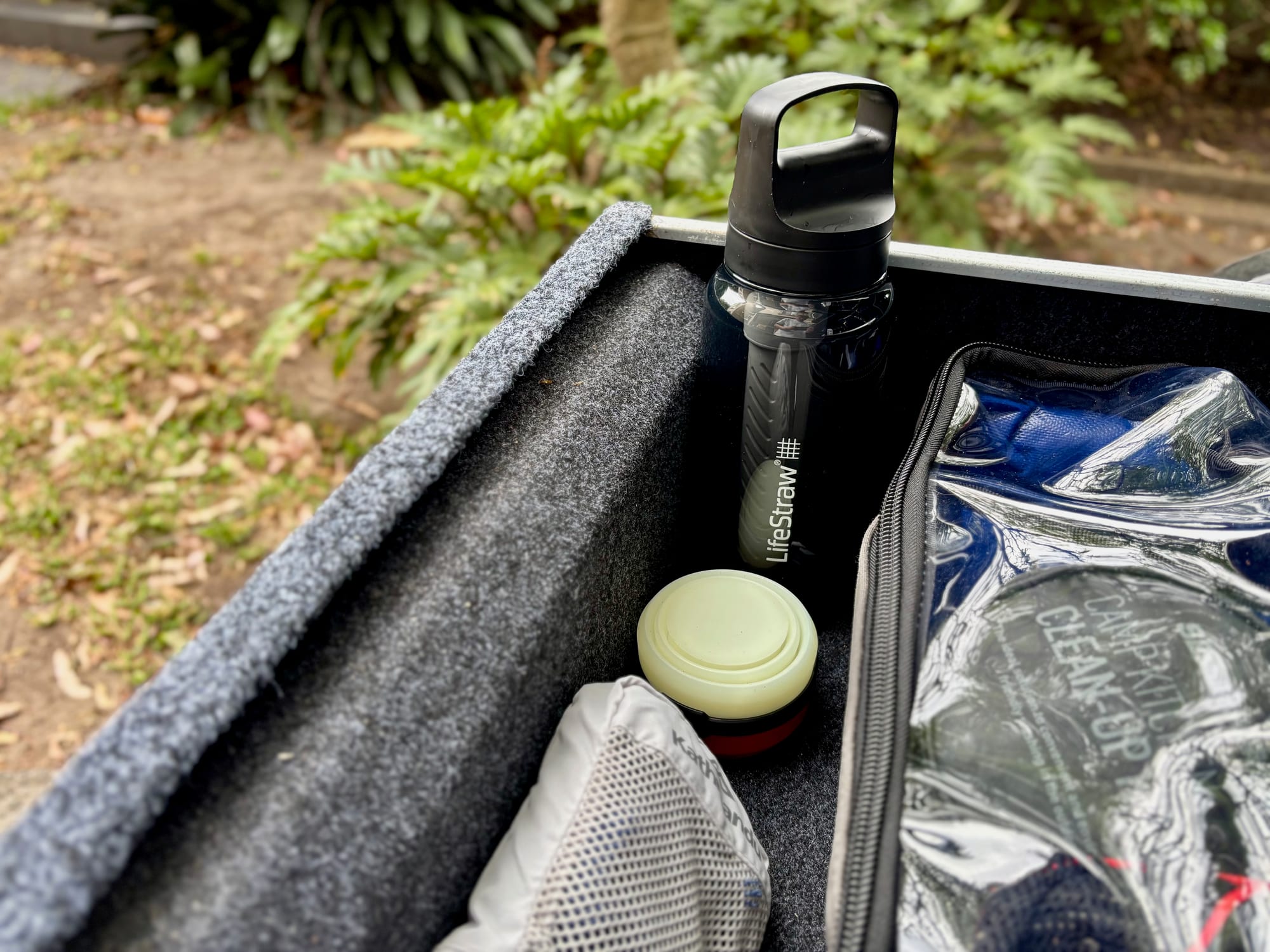 The LifeStraw Go bottle standing in the drawer of the 4WD, next to the other gear