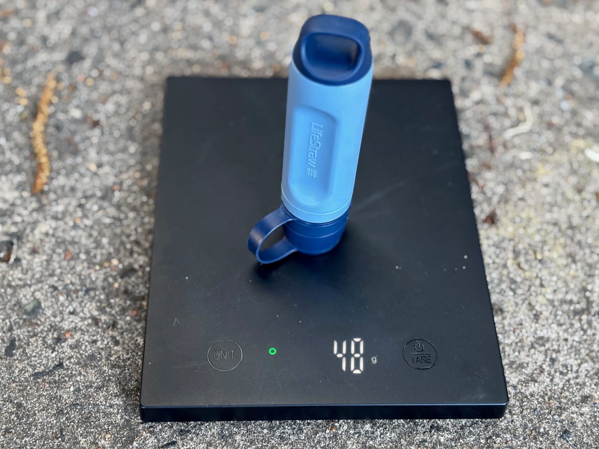 The Peak Solo standing on a kitchen scale showing 48 g