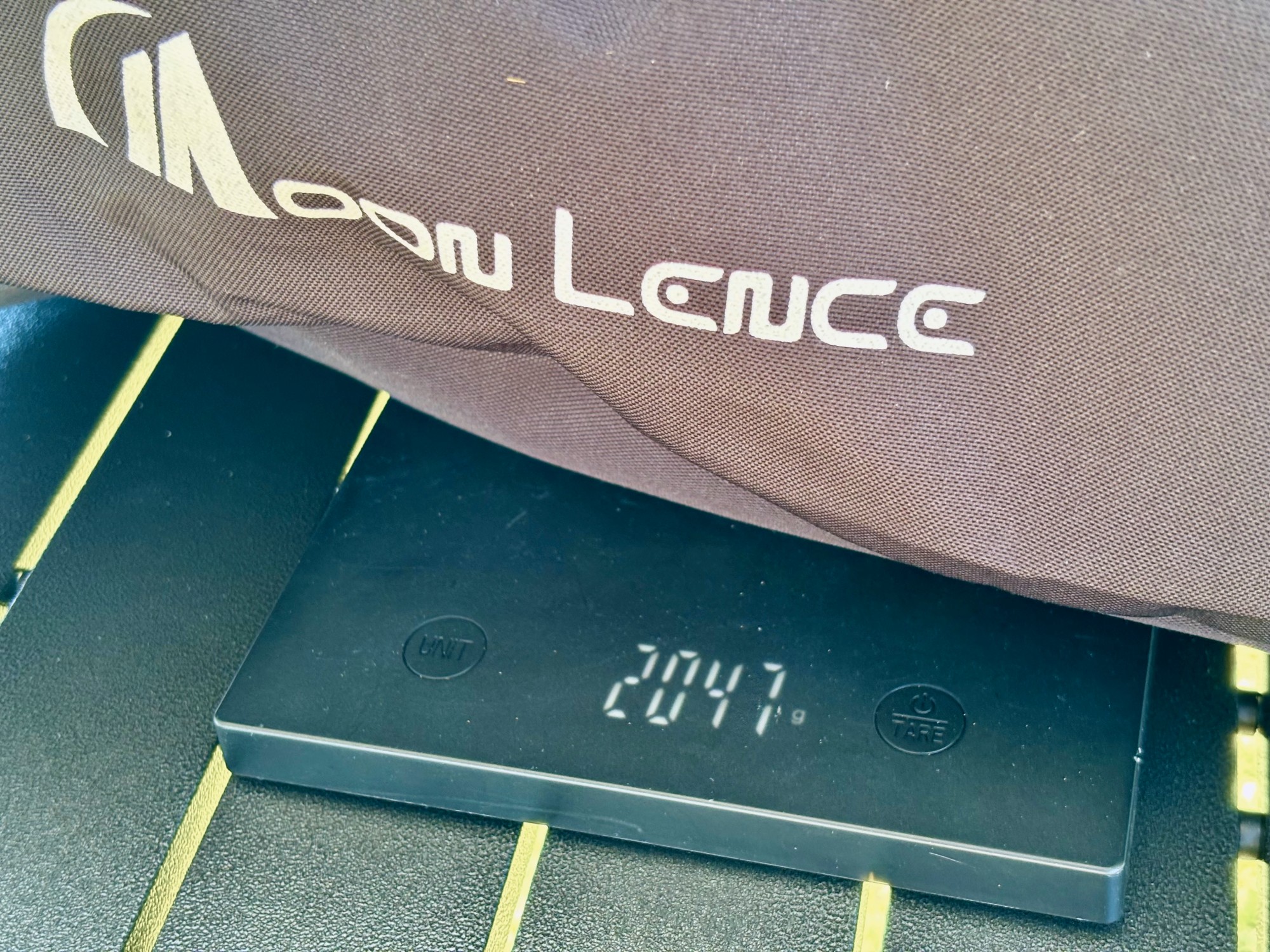 The Moon Lence high back chair on a kitchen scale showing 2,047 g