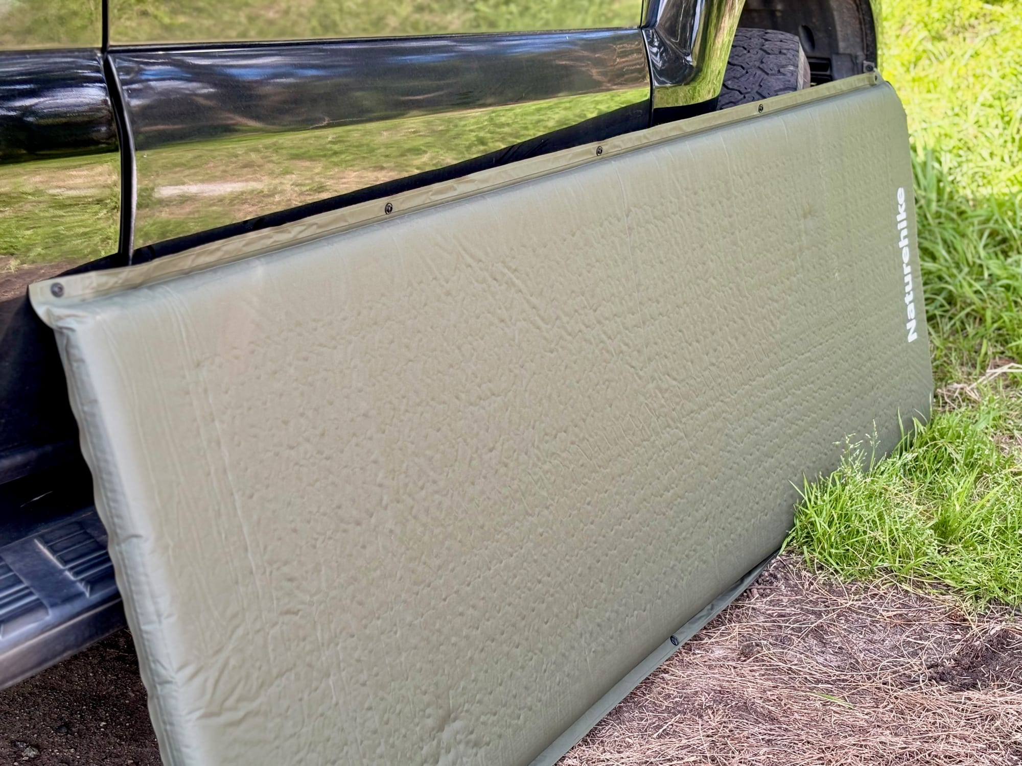 The Naturehike D-Series sleeping pad standing against the side of our 4WD
