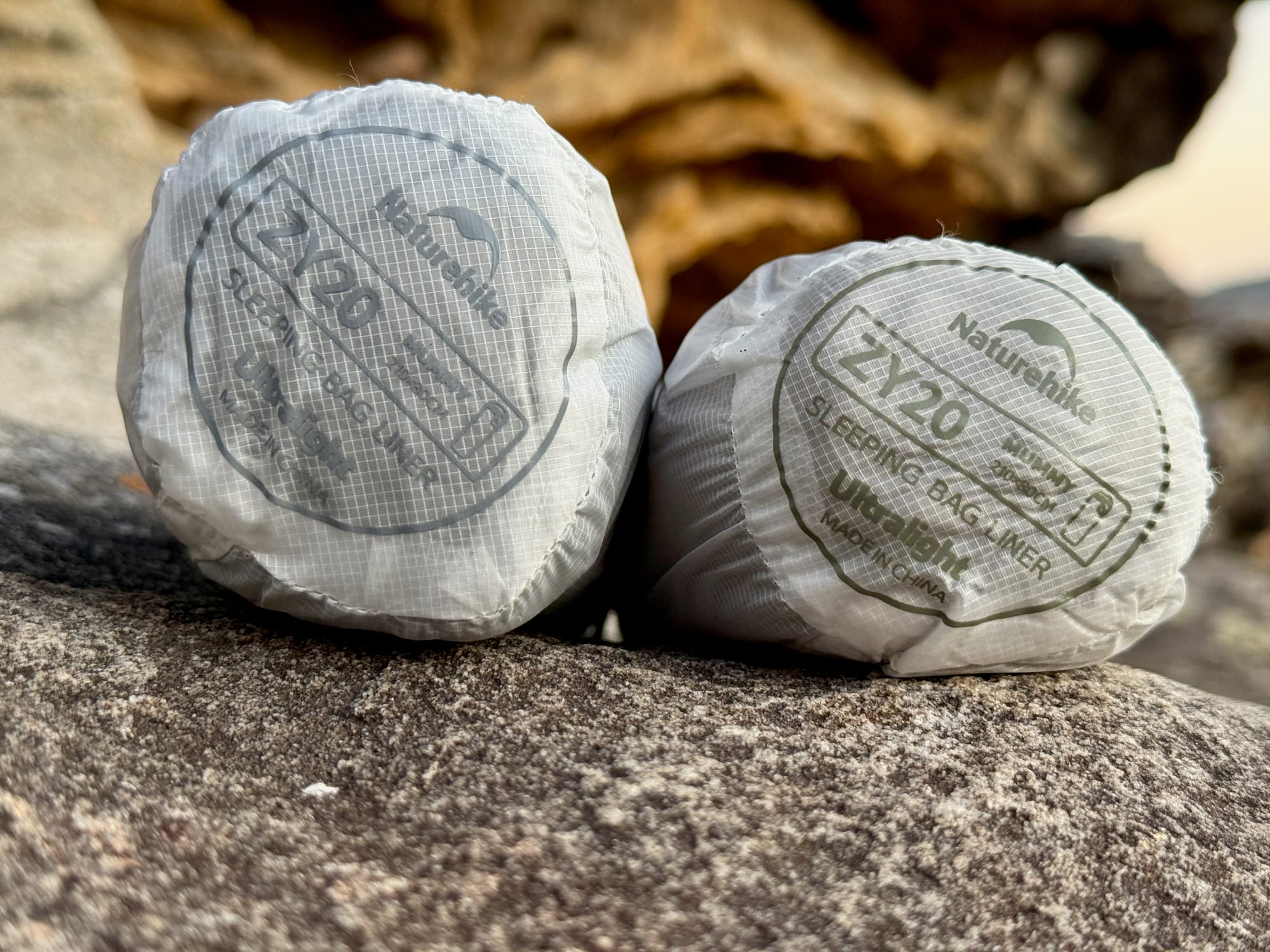 The stuff sack of the Naturehike sleeping bag liner with its printed label