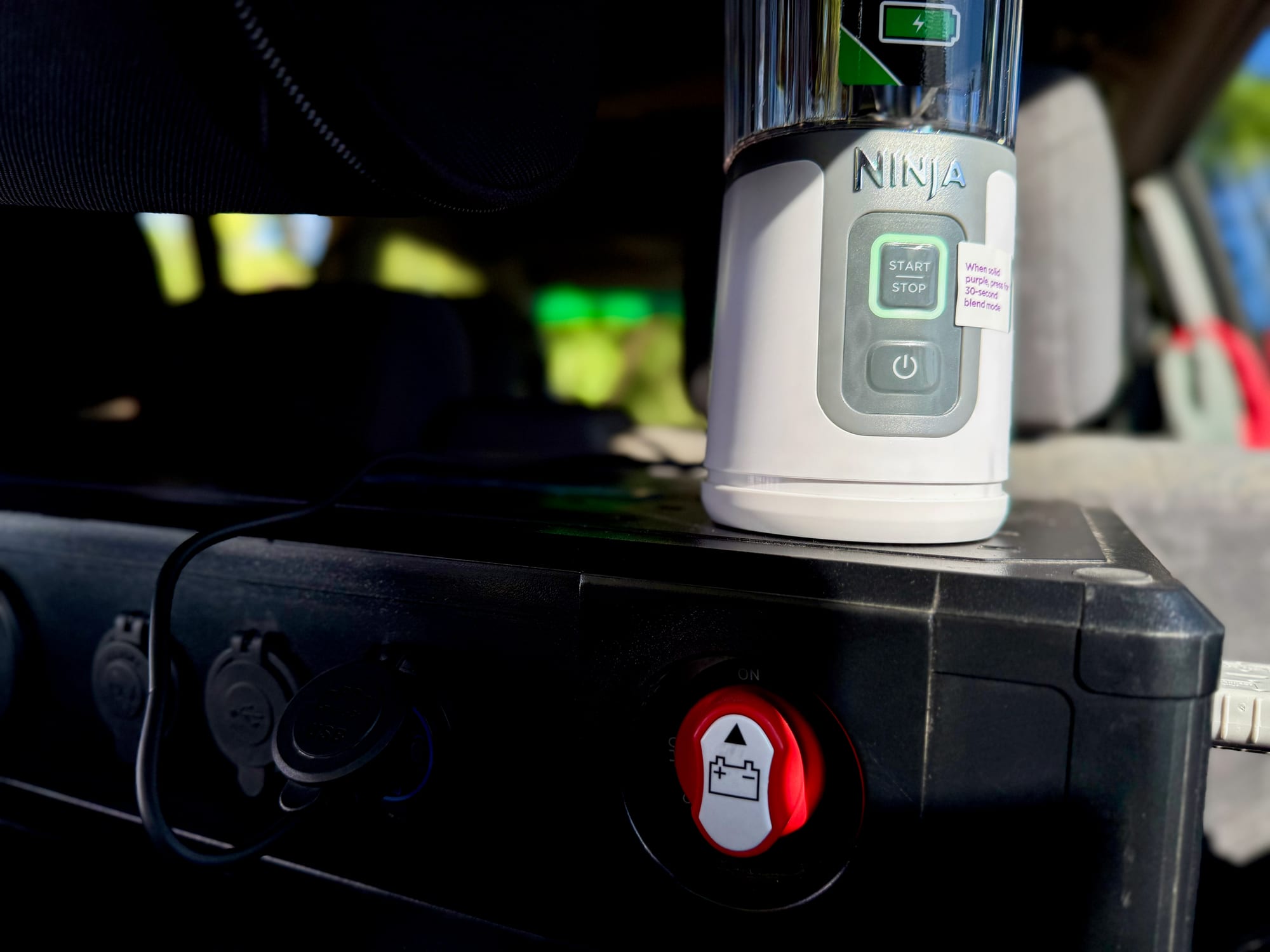 The Ninja Blast charging from the USB port in the back of the car