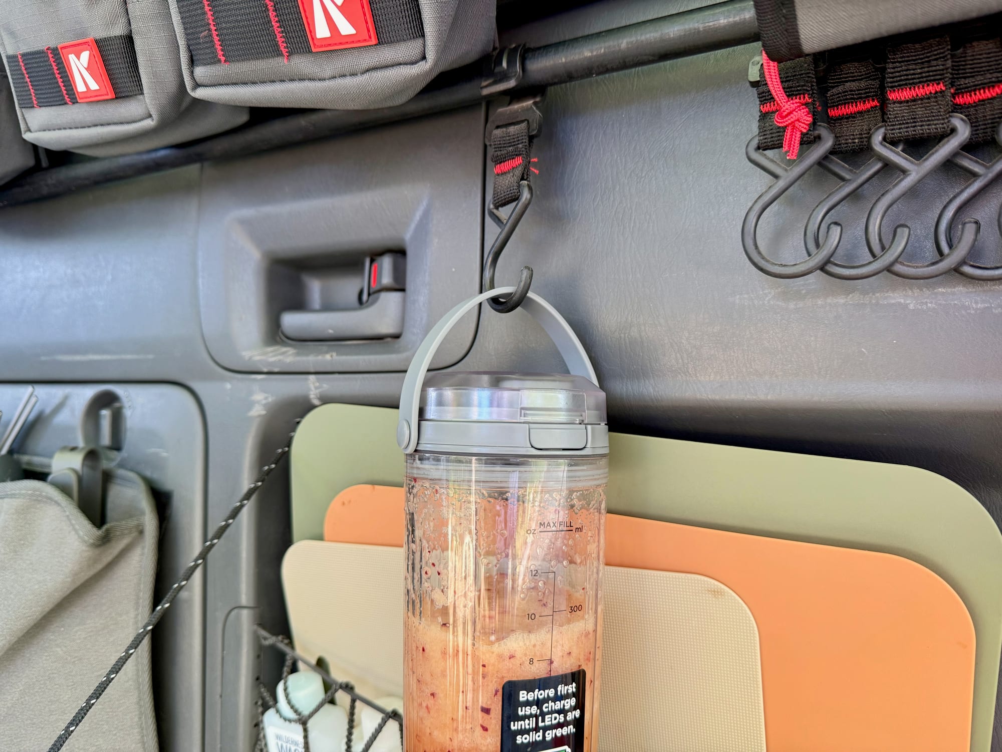 The Ninja Blast hanging from a hook in the back of the car by its carry handle