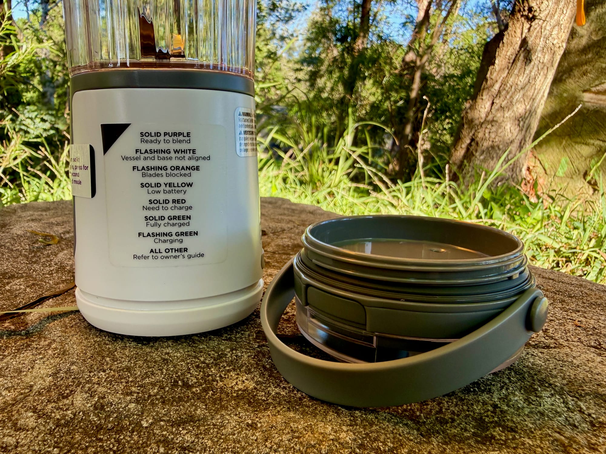 The Ninja Blast status light guide next to the lid with its carry handle