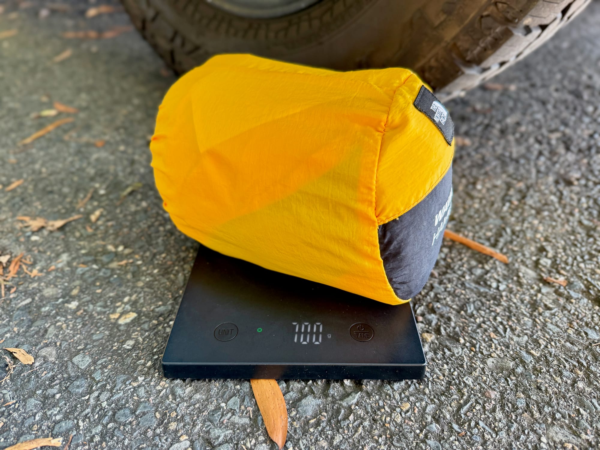 The packed North Face Wawona hammock on a kitchen scale showing 700 g