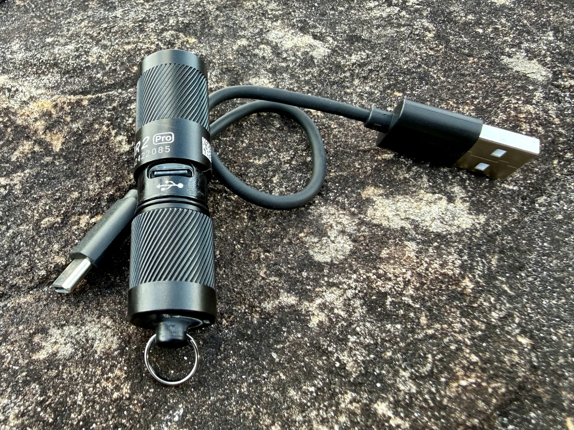 The Olight i1R 2 Pro charging through the USB-C port under its head