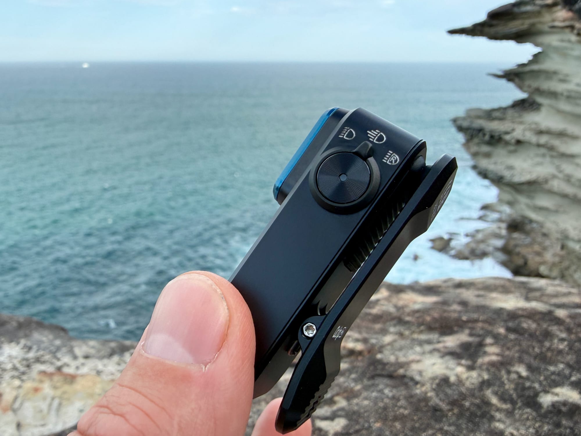 The mode dial on the side of the Olight Oclip Pro