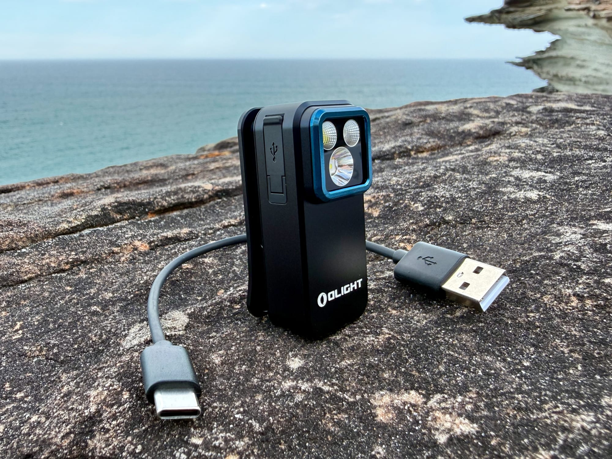 The Olight Oclip Pro with its USB-C charging cable