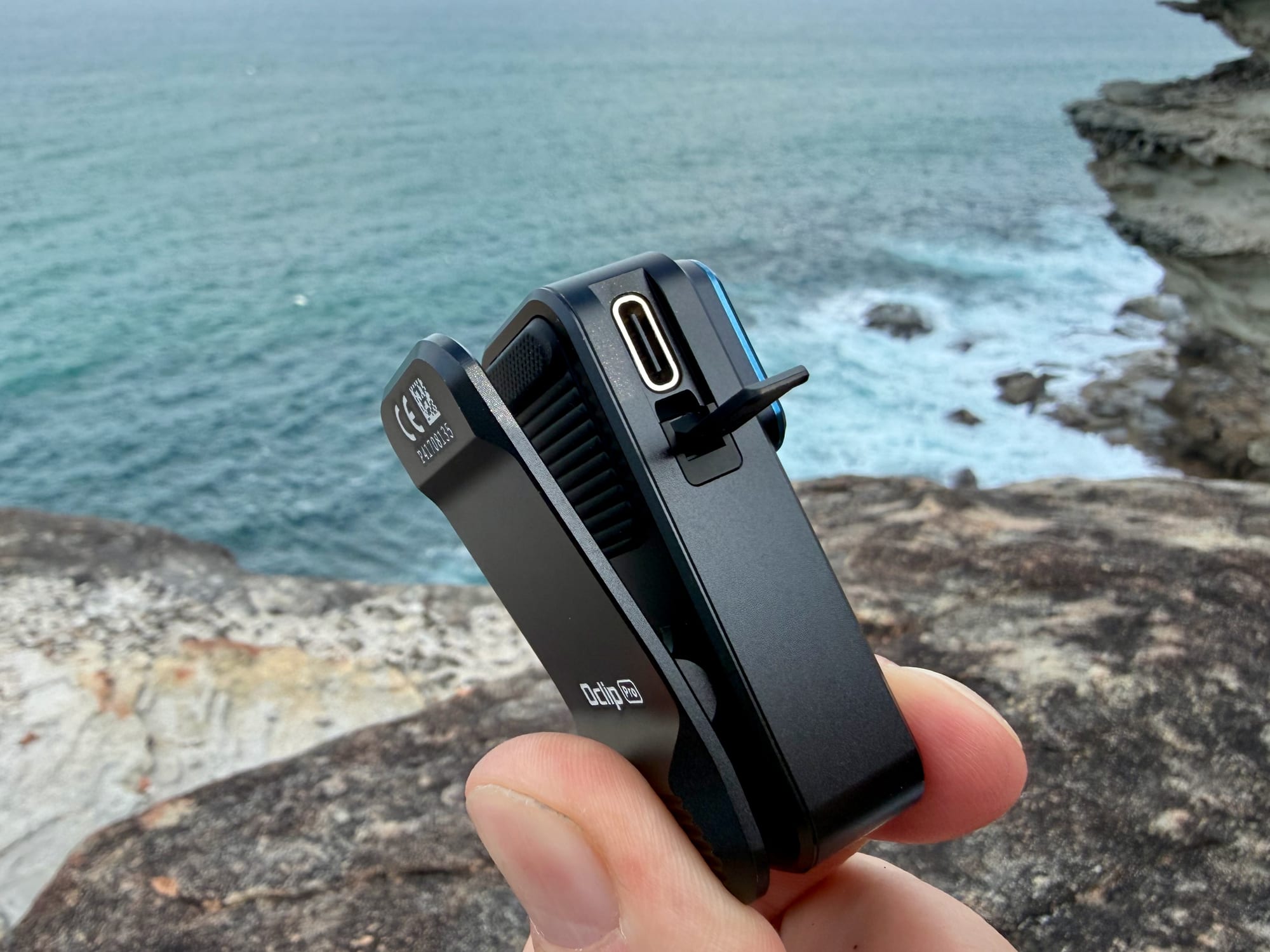 The USB-C charging port of the Olight Oclip Pro with its cover open