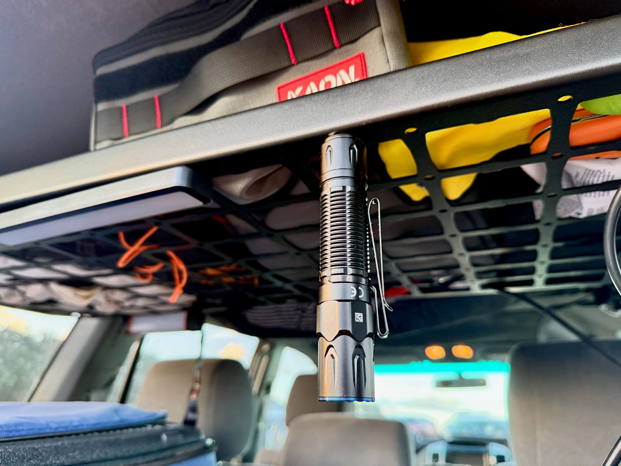The Warrior 3S stuck by its magnetic tail to the underside of a ceiling shelf in a 4WD, hanging head down
