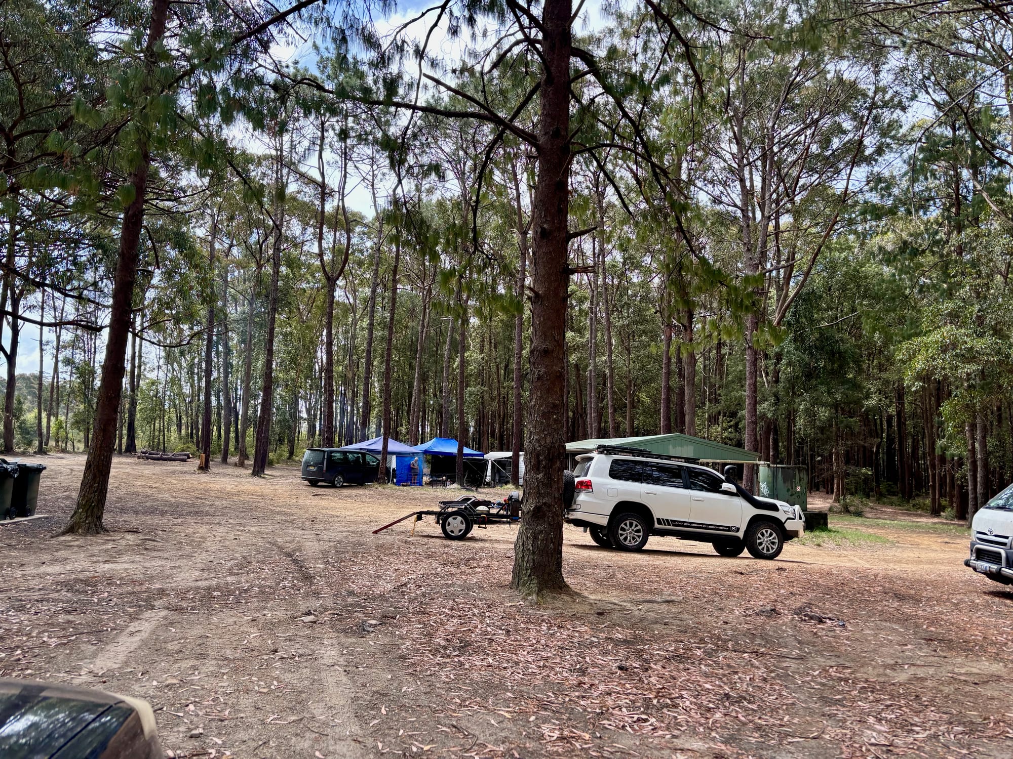 The open, flat camping area at Olney Headquarters, with vehicles and gazebos set up