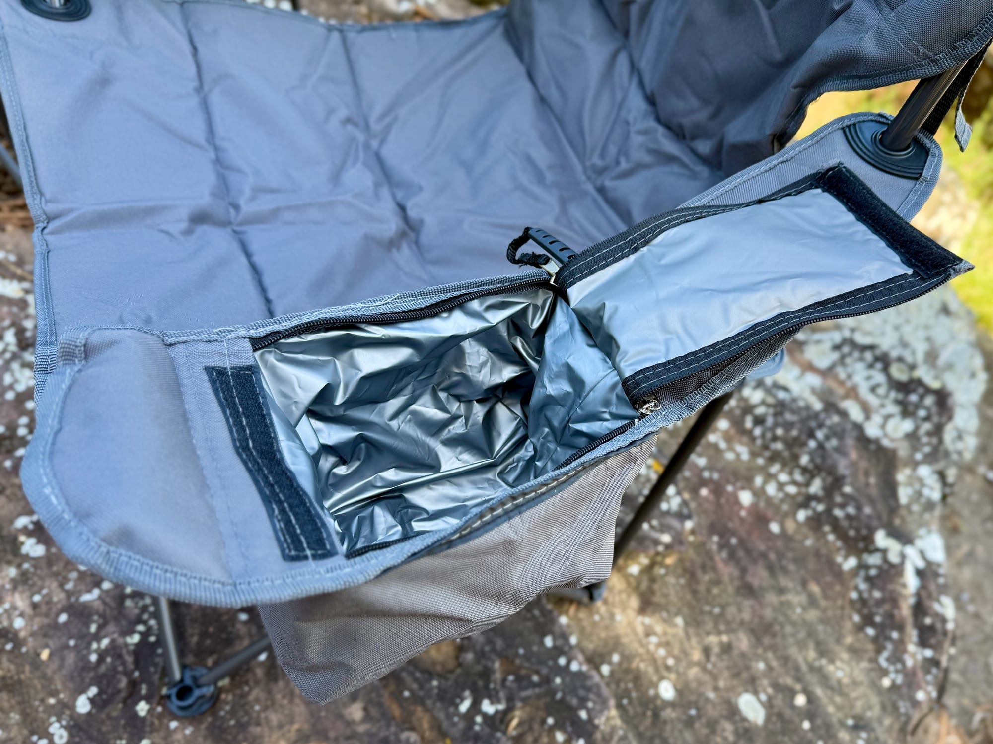 The zippered arm cooler of the OZtrail Getaway Chair, open