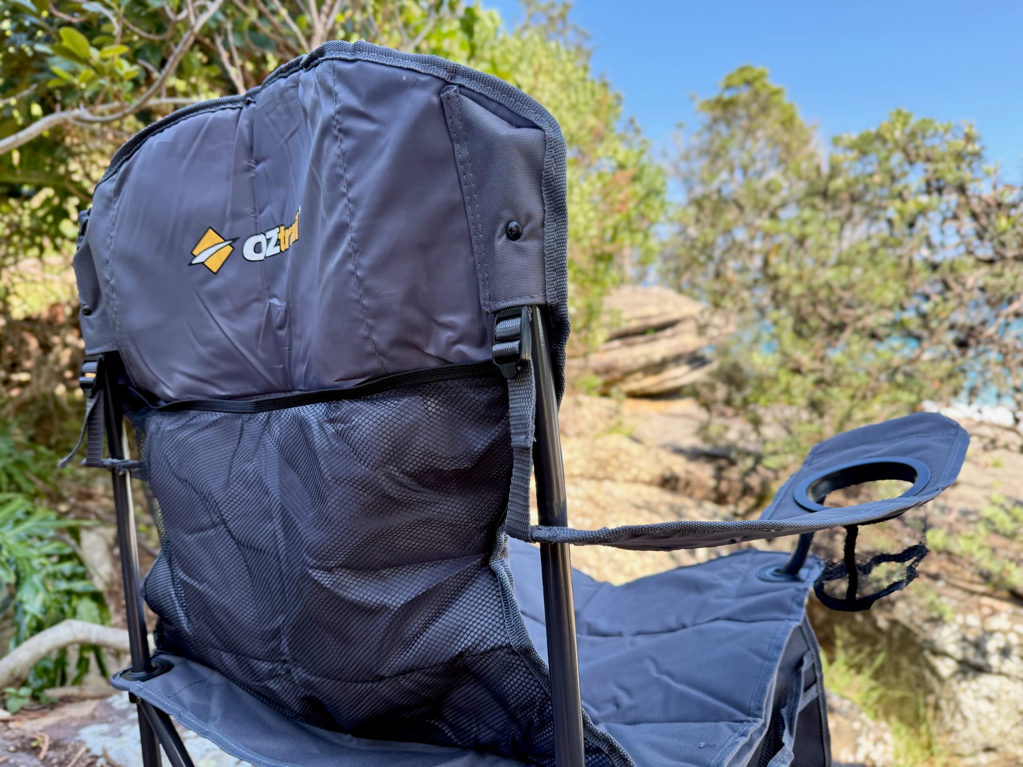 The back of the Getaway Chair with its mesh storage pocket, and the drink holder on the arm