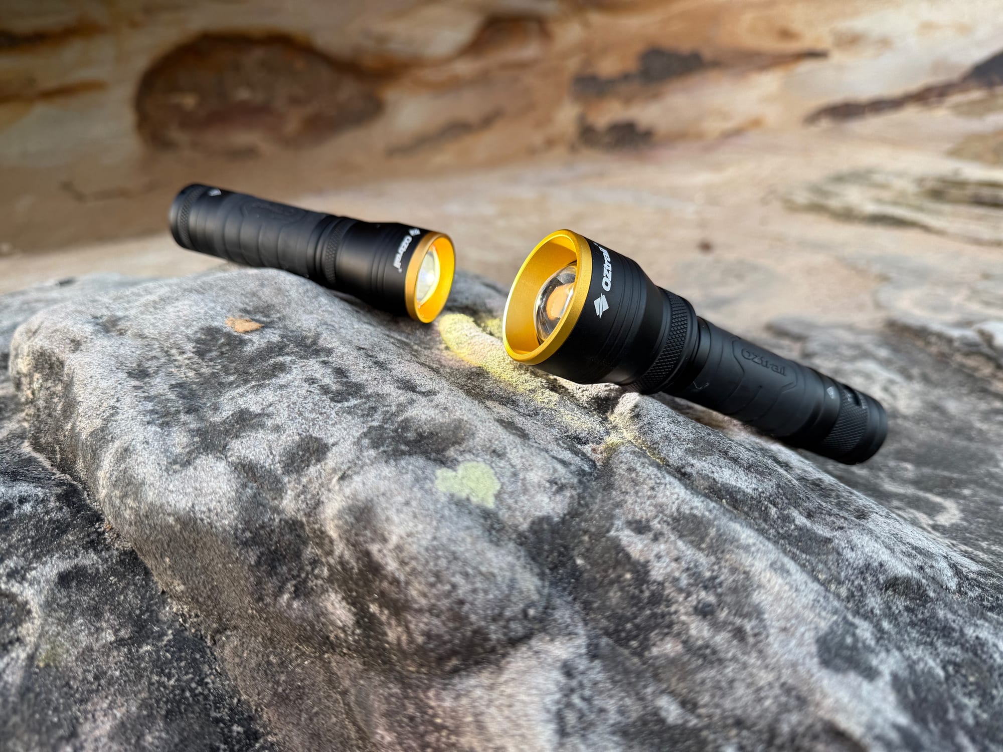 The small OZtrail Lumos F300 next to the bigger FR800 on a sandstone rock