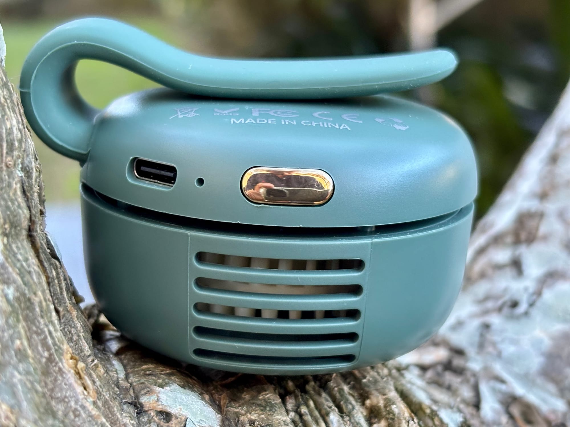 The side of the mini bladeless fan with its USB-C port, button and air slots
