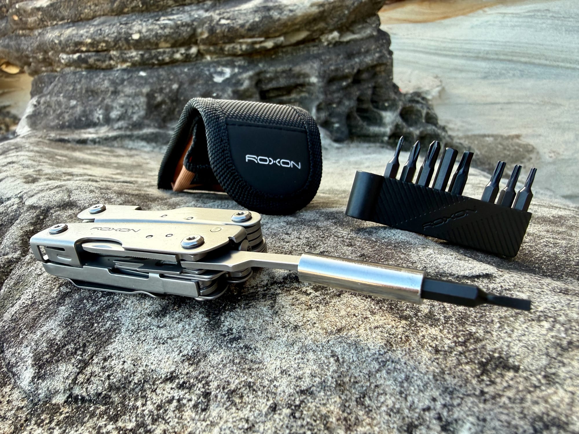 The bit extender fitted to the Roxon M2, with the pouch and the bit strip behind it