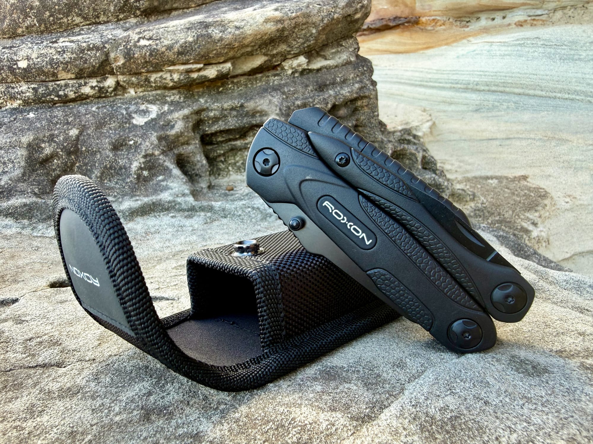 The Roxon Spark next to its black belt pouch