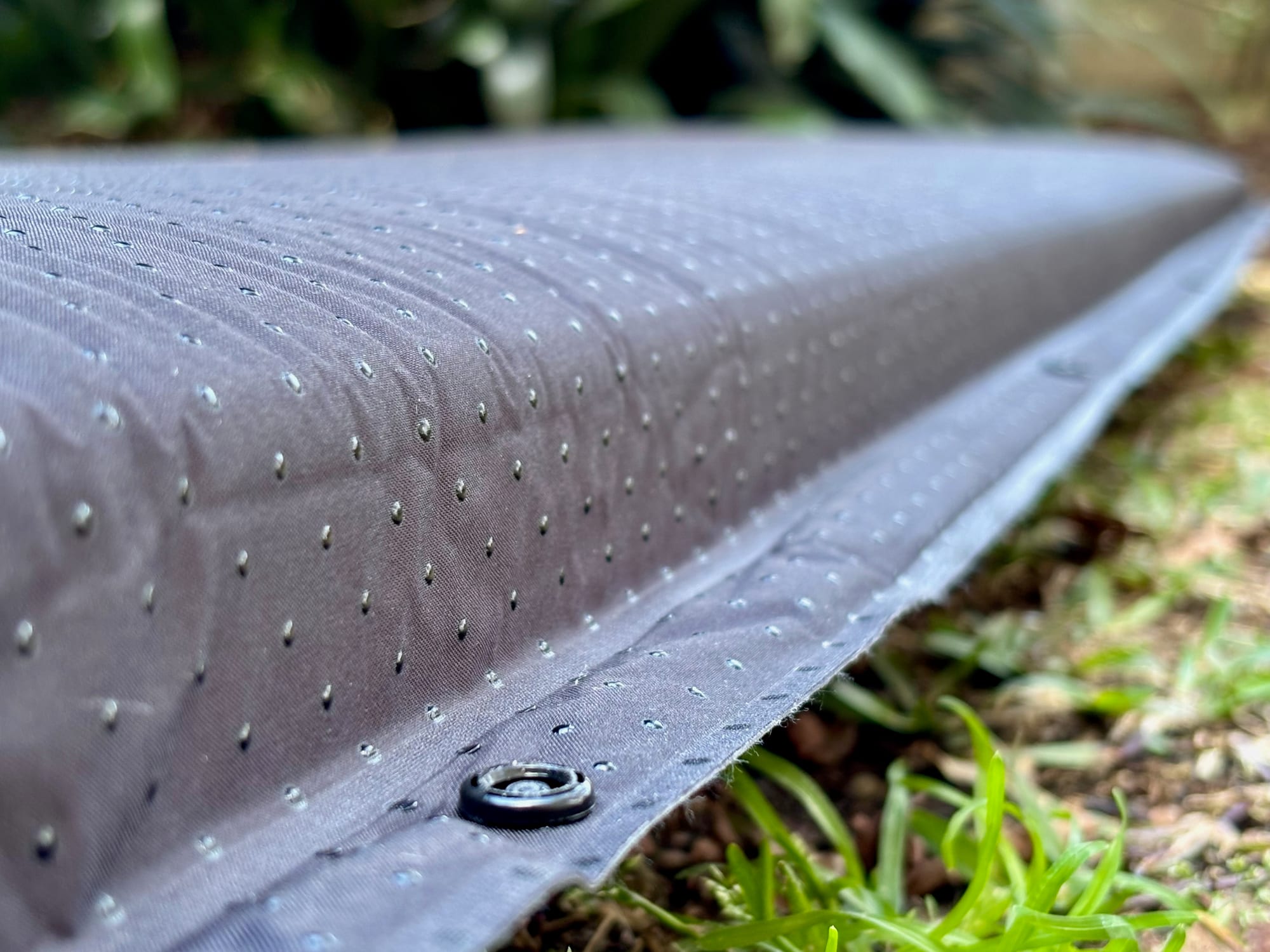 A snap button on the edge of the San Hima self-inflating mattress