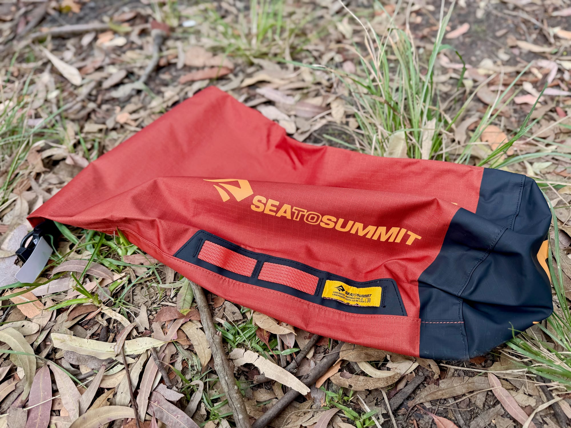 The Big River dry bag laid flat, showing the lash points and the dark base
