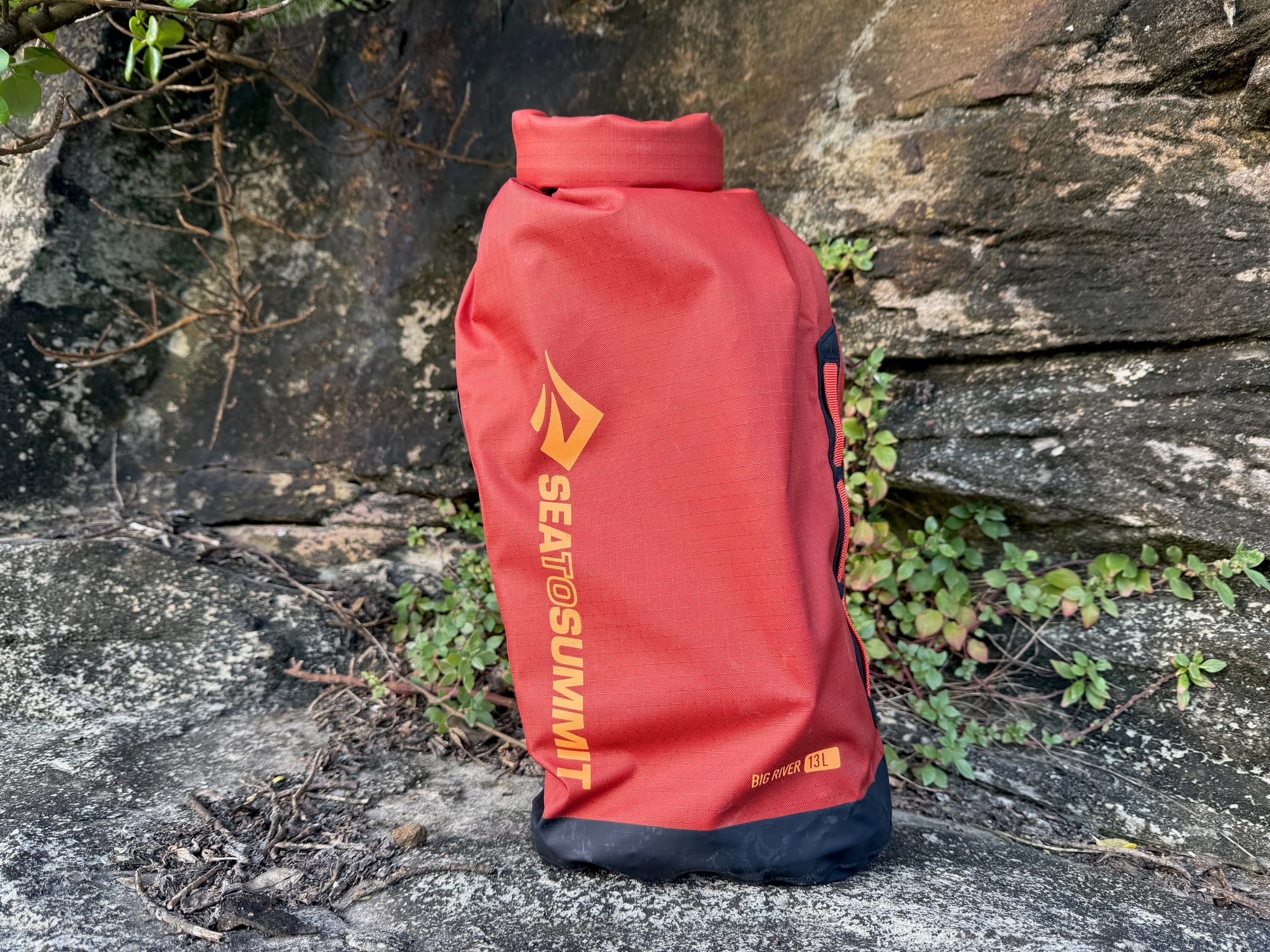The Big River 13L packed, rolled shut and standing on a rock ledge