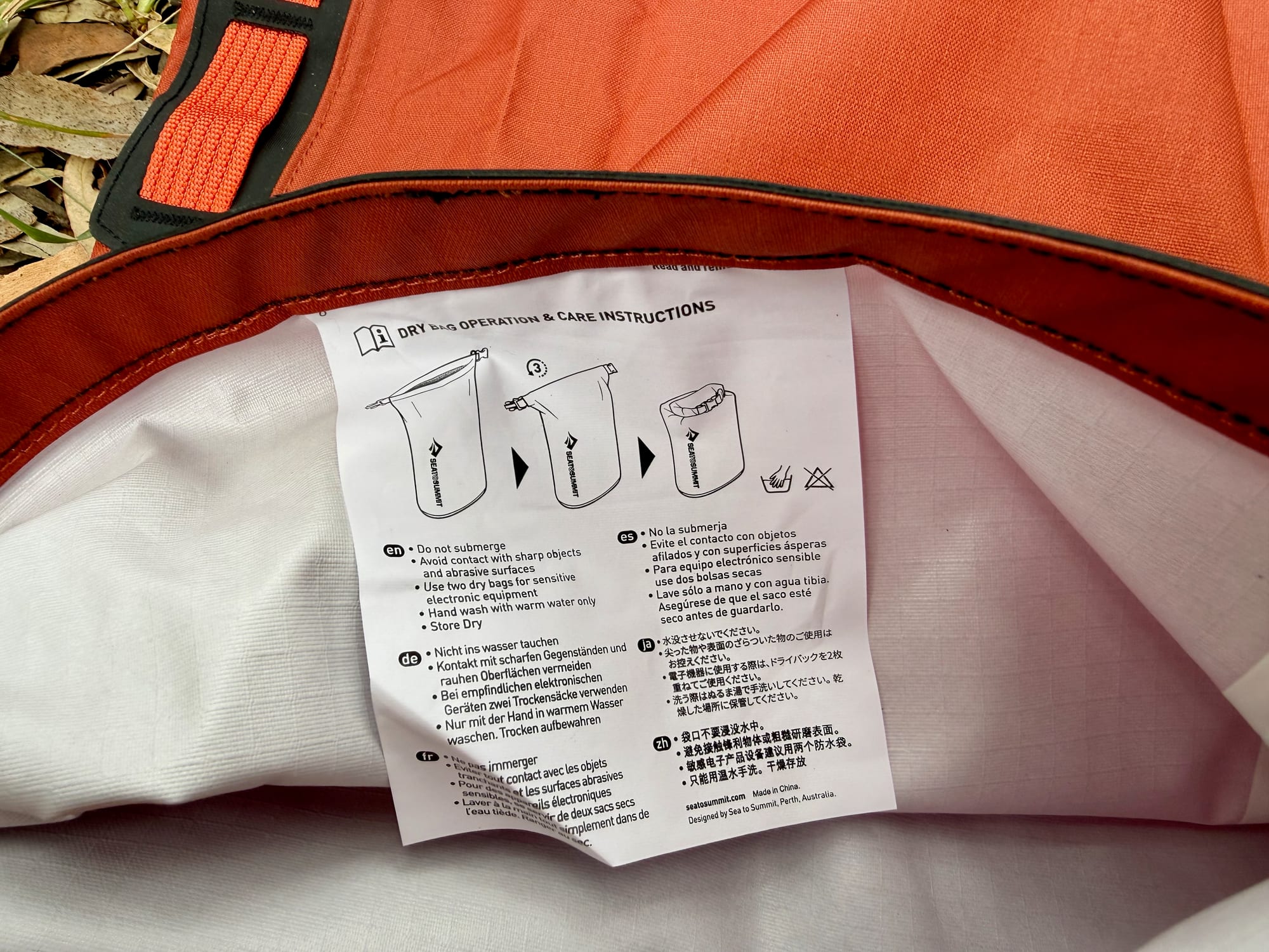 The white lining of the Big River dry bag, with the care instructions inside