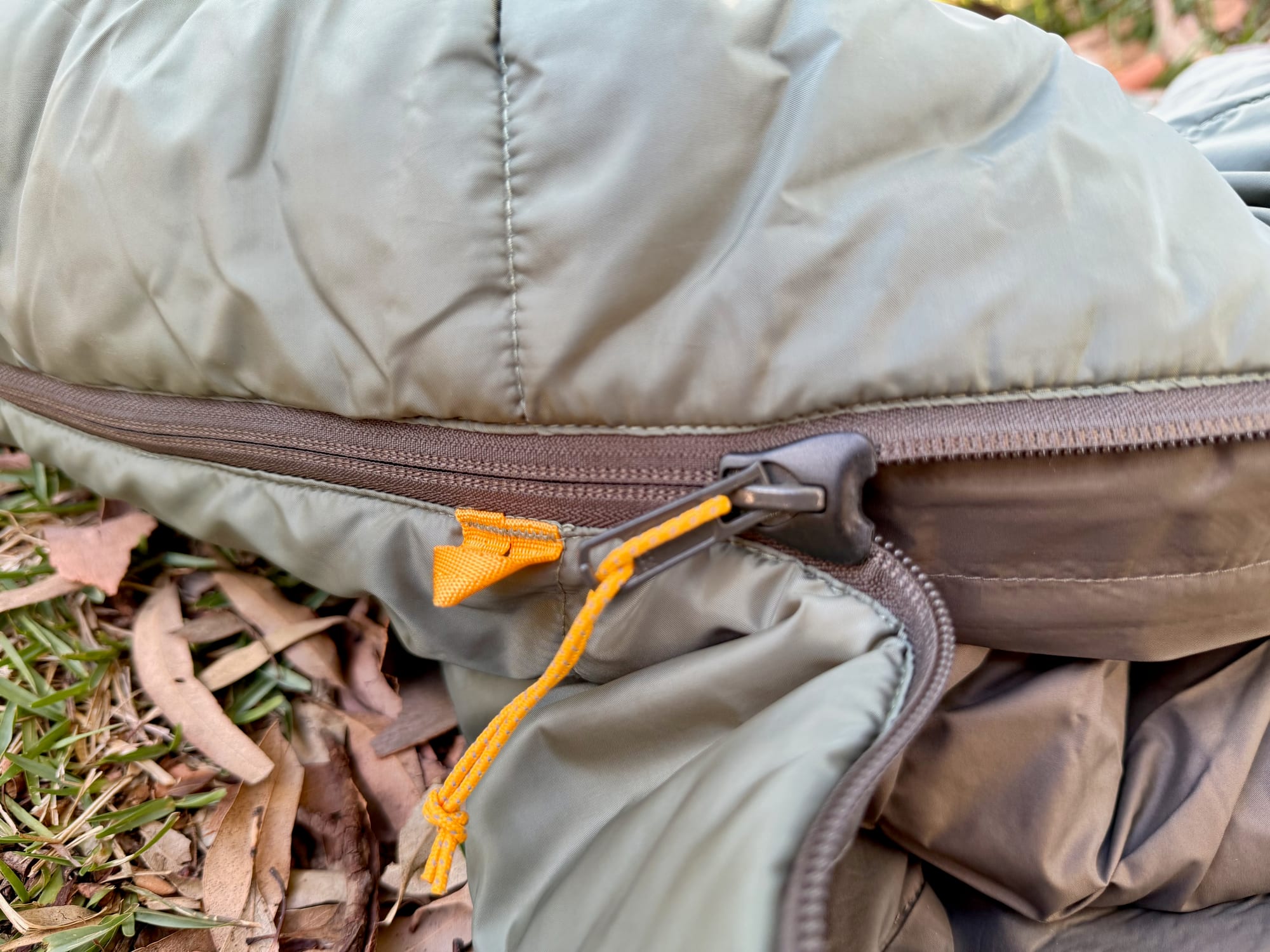 The zip plough on the slider, with the shell and lining fabric up close