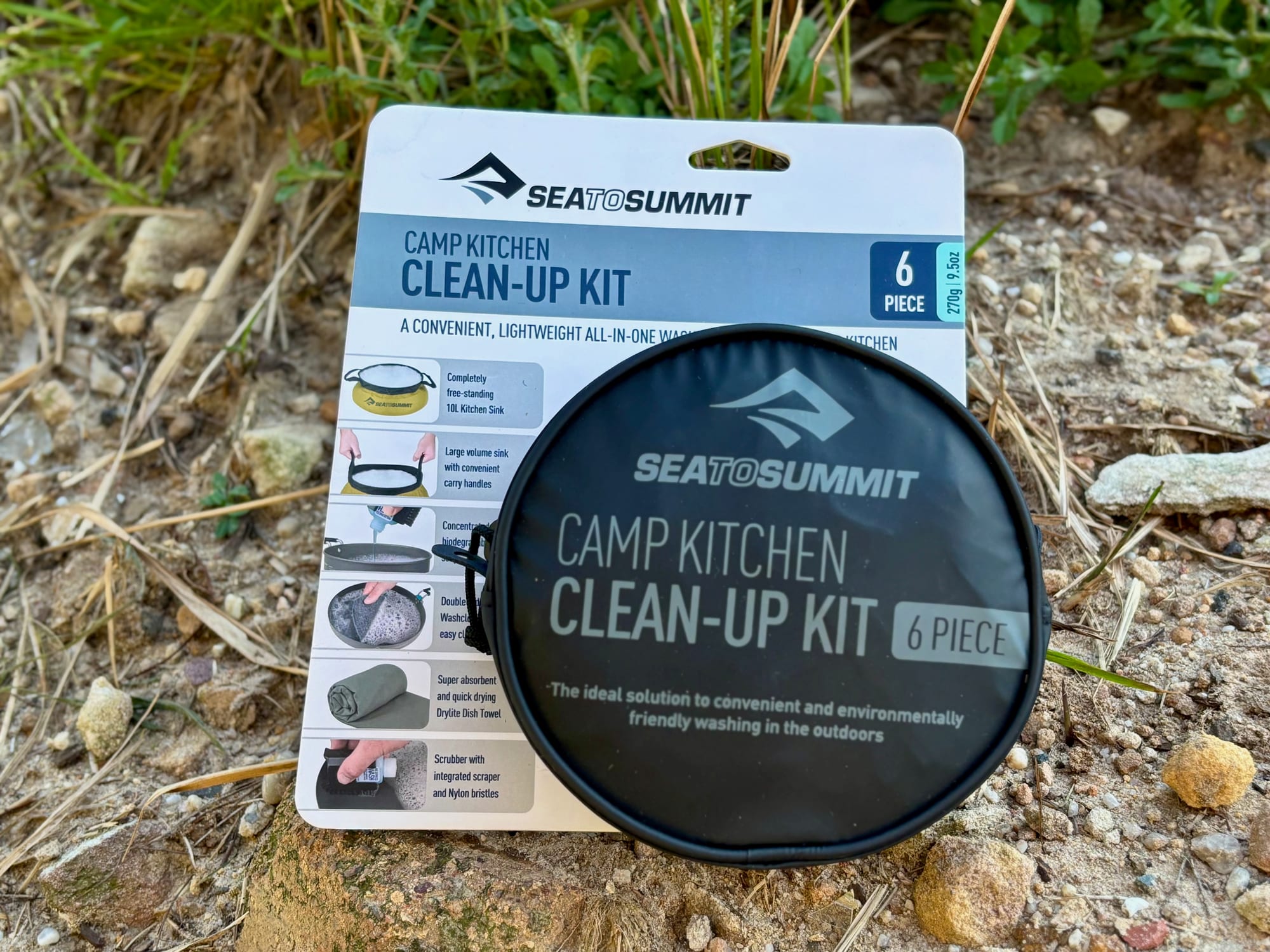 The Sea to Summit Camp Kitchen Clean-Up Kit in its case, in front of its card