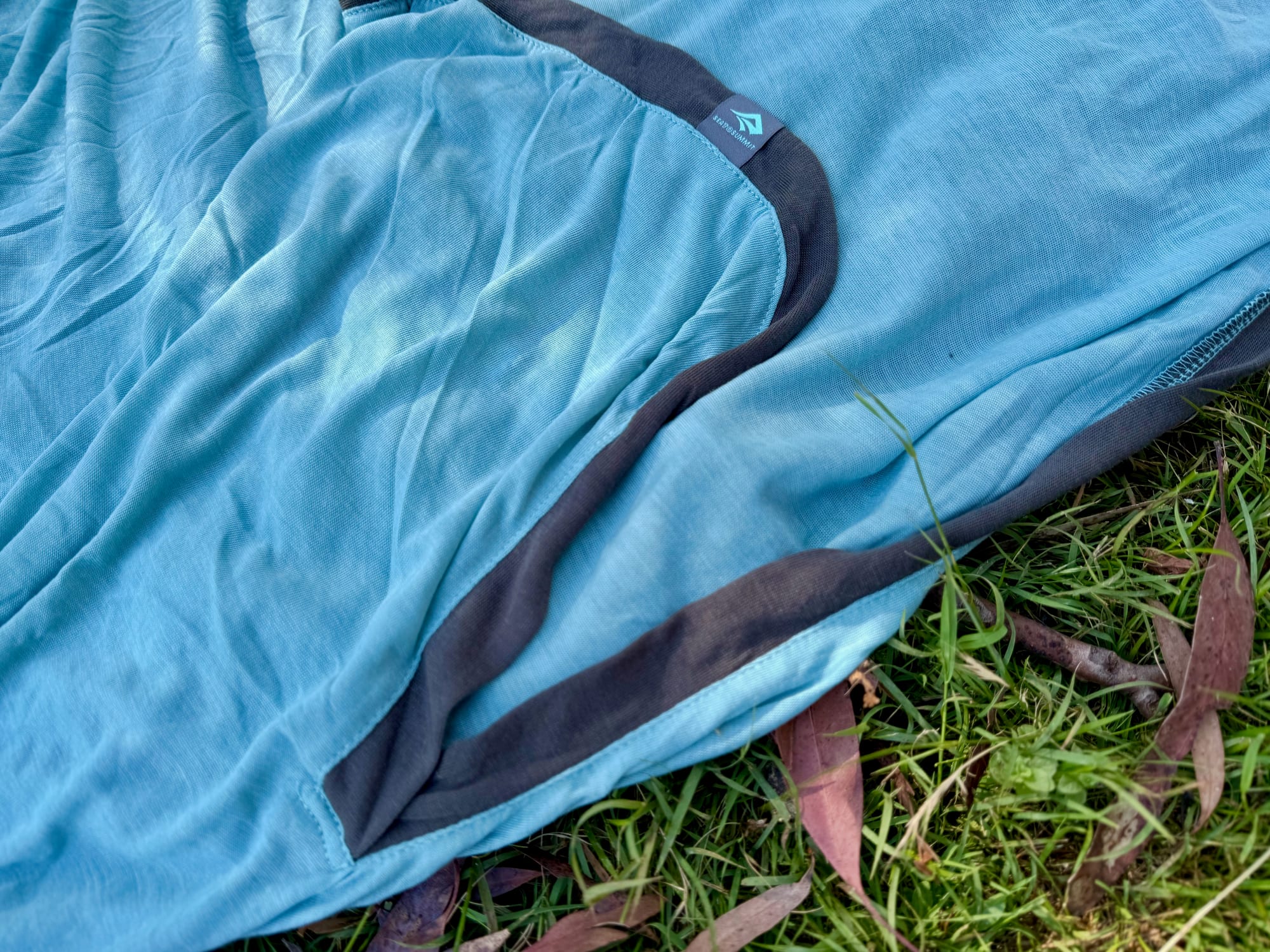 Close-up of the soft aqua Coolmax and Tencel knit of the Comfort Blend liner, with its dark grey trim