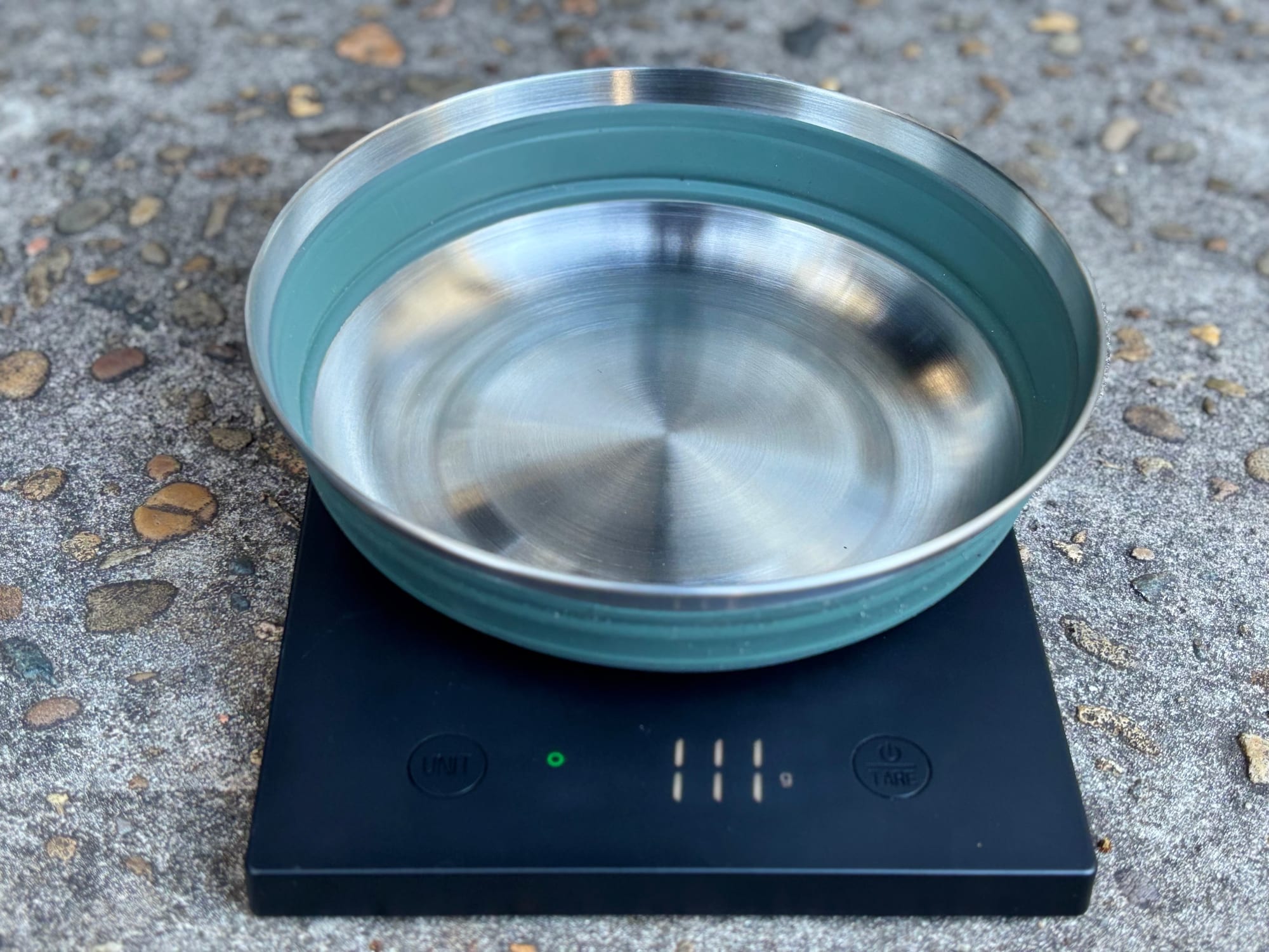 A green Detour bowl on a digital scale showing 111 grams