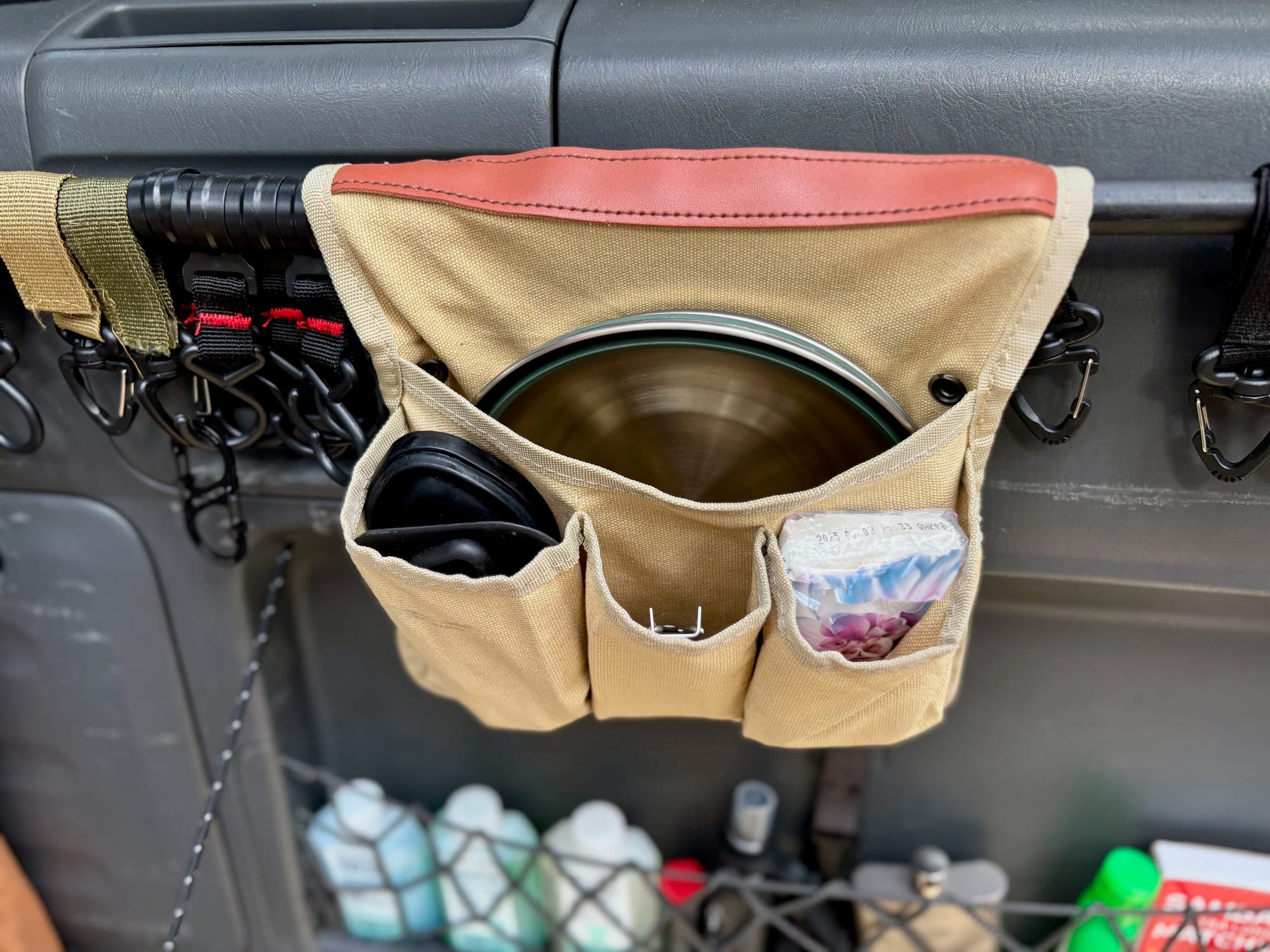 Detour bowls and mugs in a canvas organiser hanging on the tailgate of our 4WD