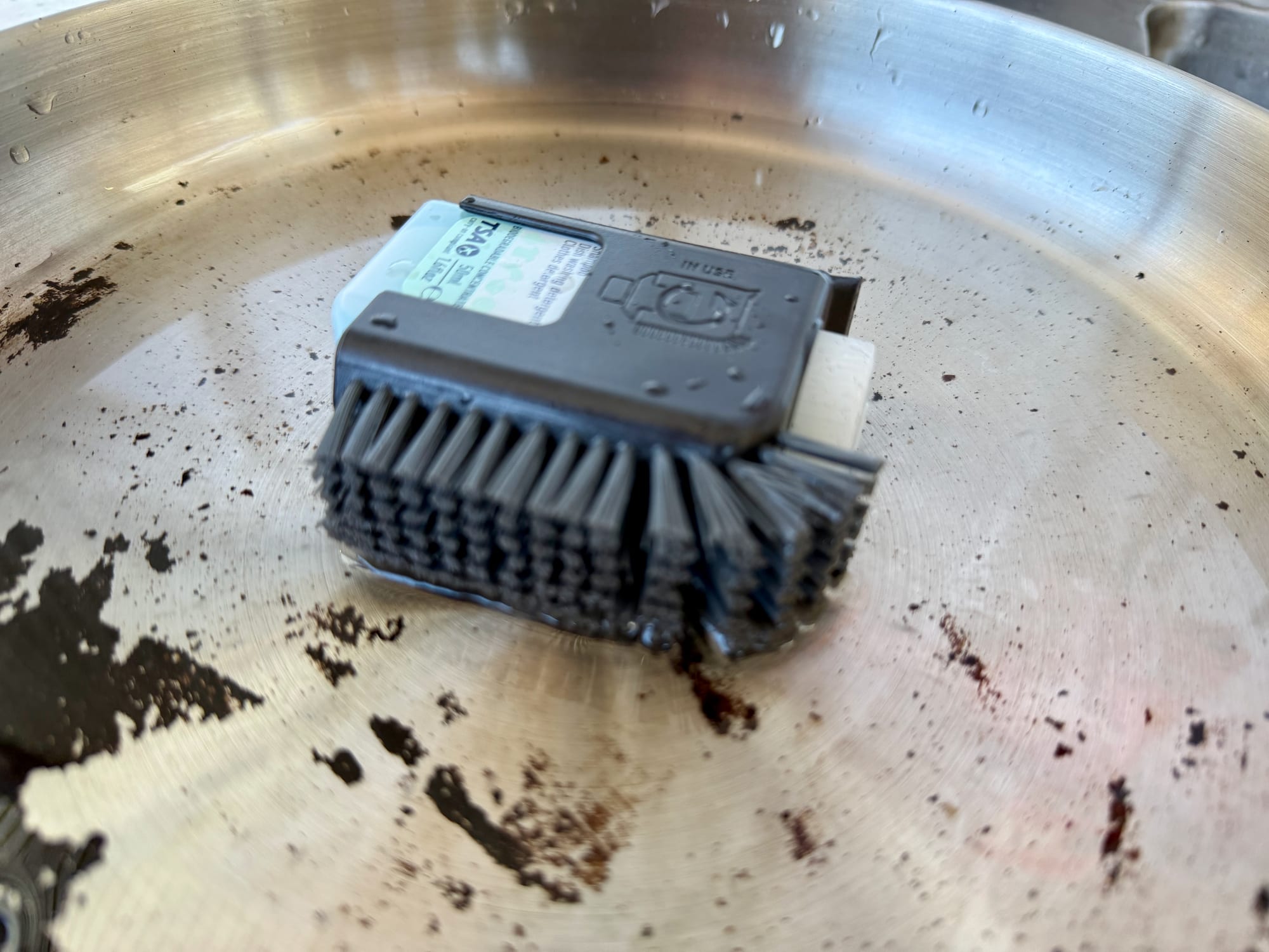 The Sea to Summit Pot Scrubber in the Detour Pan with burnt-on egg stains