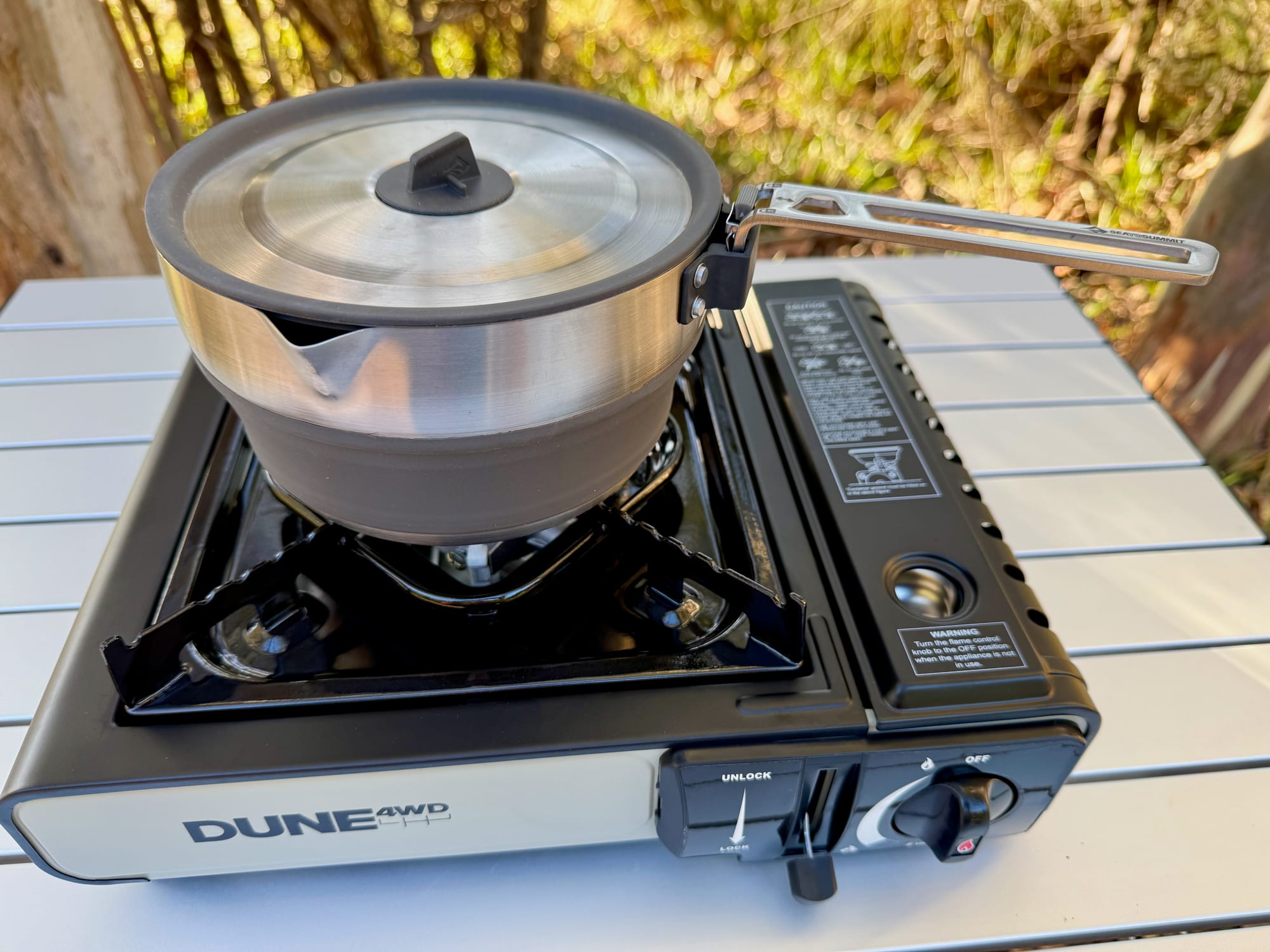 The Sea to Summit Detour Pot with its lid on, on a Dune single burner butane stove