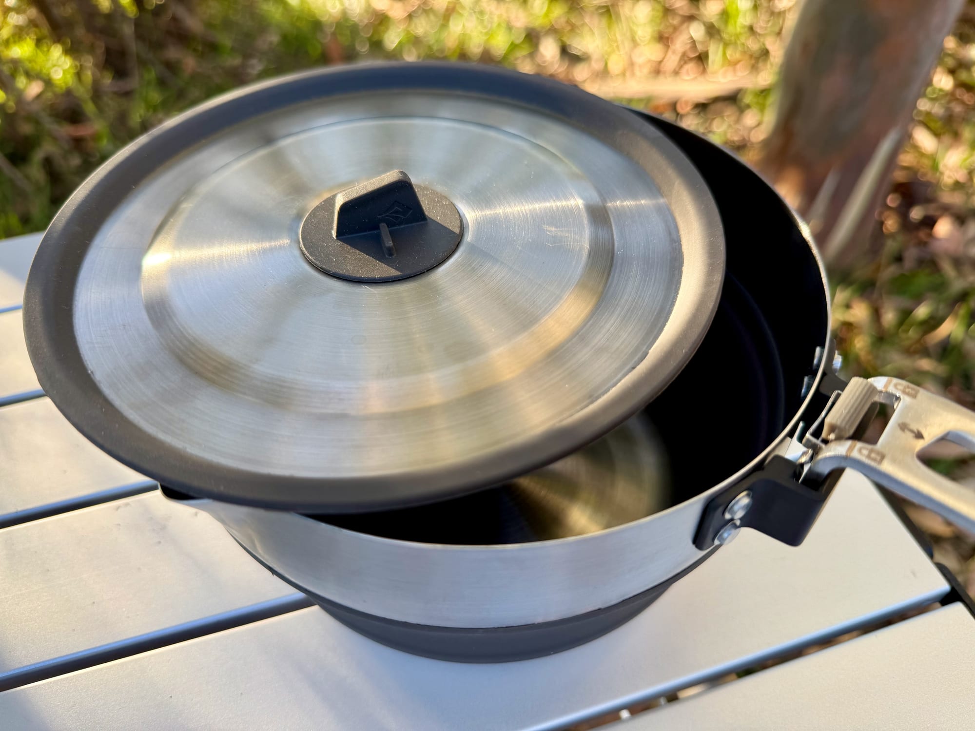 The Sea to Summit Detour Pot opened up with its lid on and the handle folded out