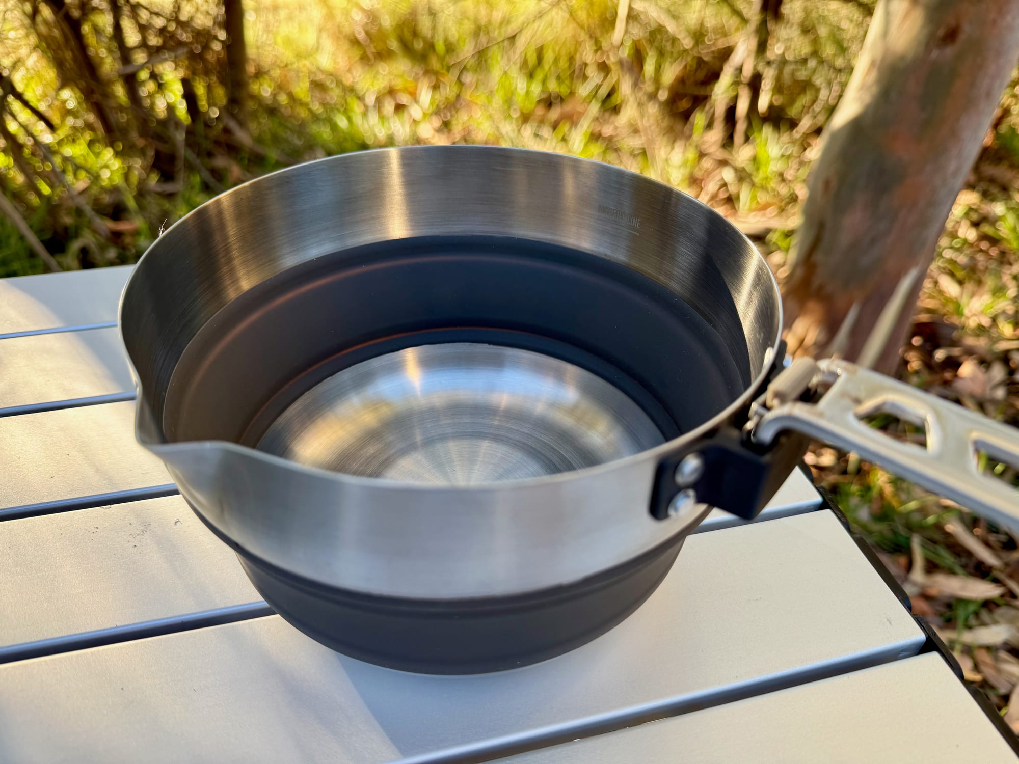 The open Sea to Summit Detour Pot showing the pouring spout in the stainless steel rim