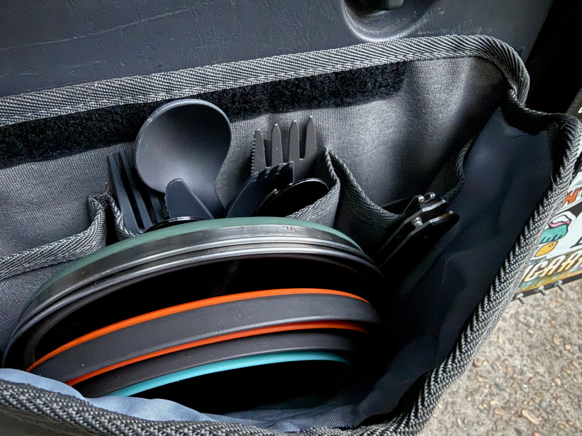 Collapsed Frontier bowls packed in a car organiser with cutlery