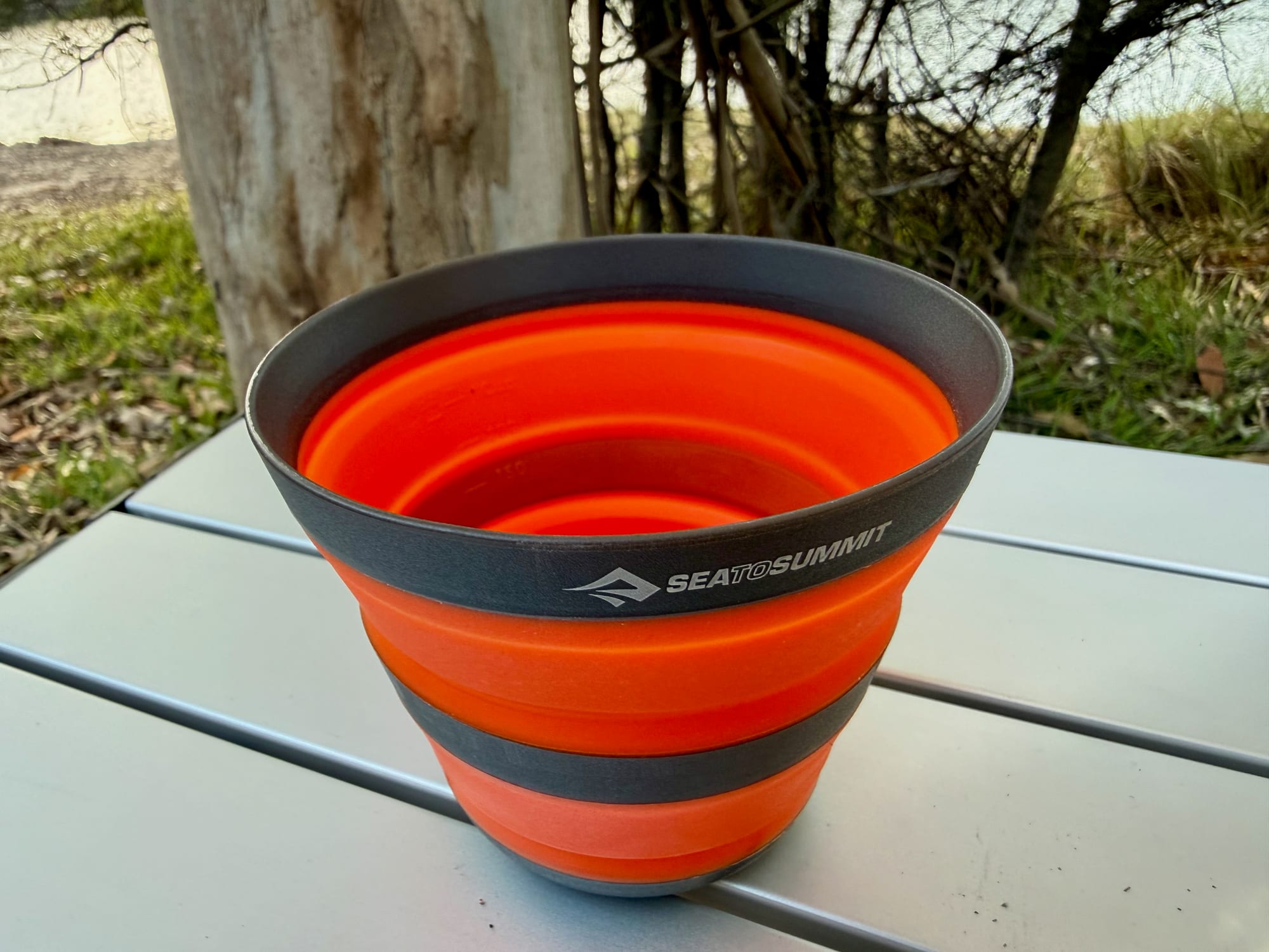 Looking into the open Frontier collapsible cup, with its grey rim and orange silicone sides