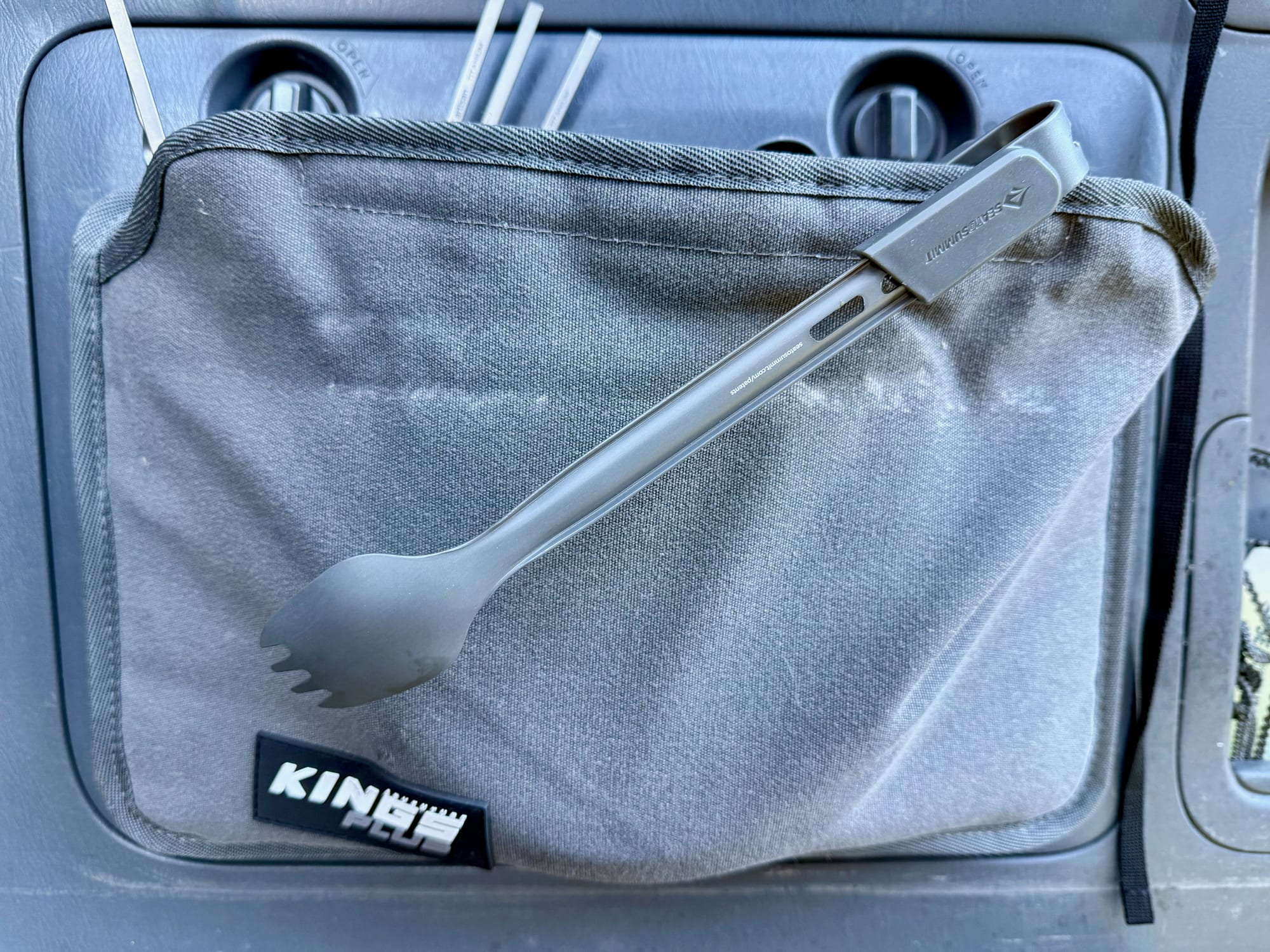The clipped Frontier UL cutlery set lying on a storage bag in the car