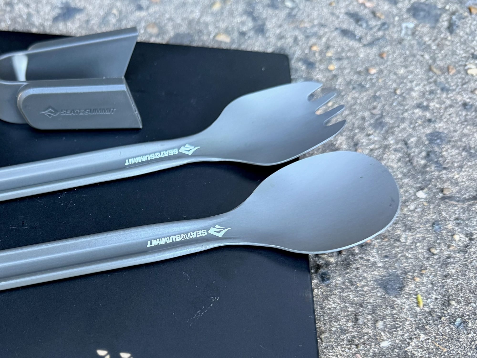 The Frontier UL spork and spoon up close, with the clip beside them