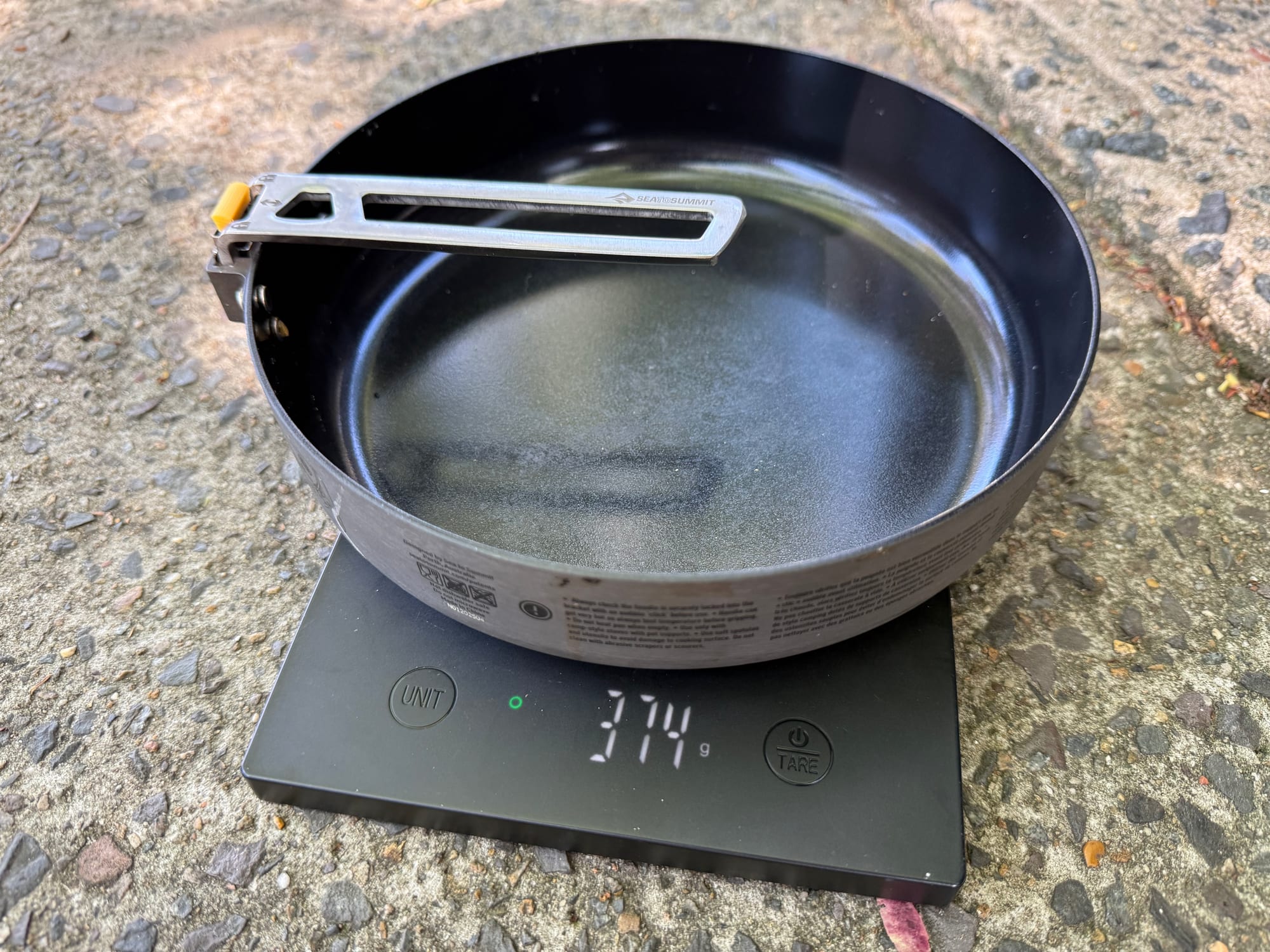 The Sea to Summit Frontier Ultralight Pan on a digital scale showing 374 g