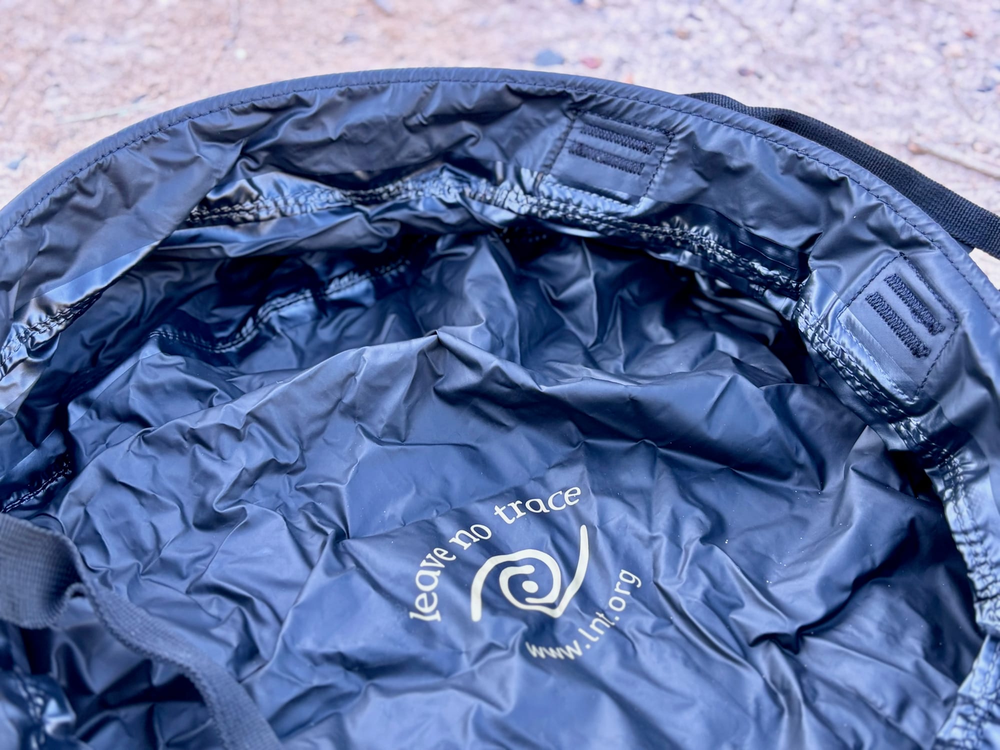 The black inside of the Sea to Summit Kitchen Sink with the Leave No Trace logo printed on the bottom