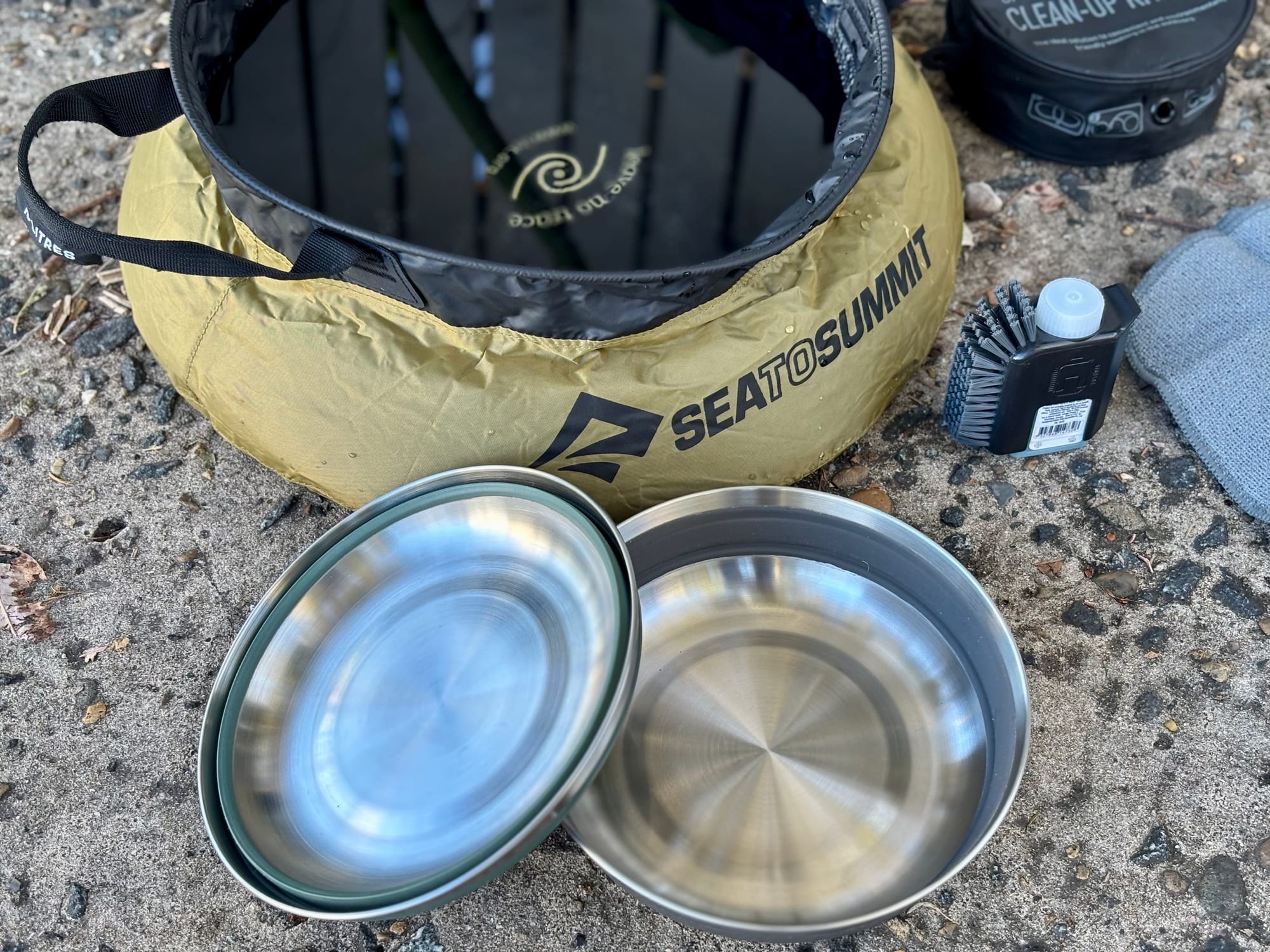 The Sea to Summit Kitchen Sink with two Sea to Summit Detour stainless steel bowls in front of it