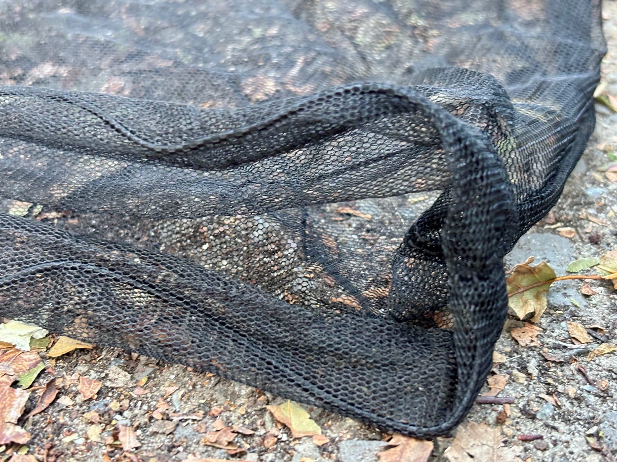 The fine black hexagonal mesh and the hem of the Sea to Summit Head Net