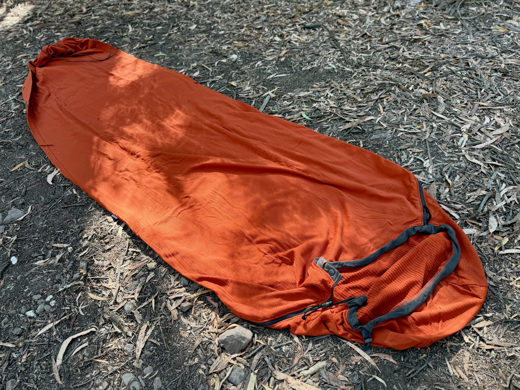 The Reactor Fleece liner laid out full length on the ground, tapering to its drawn-closed footbox