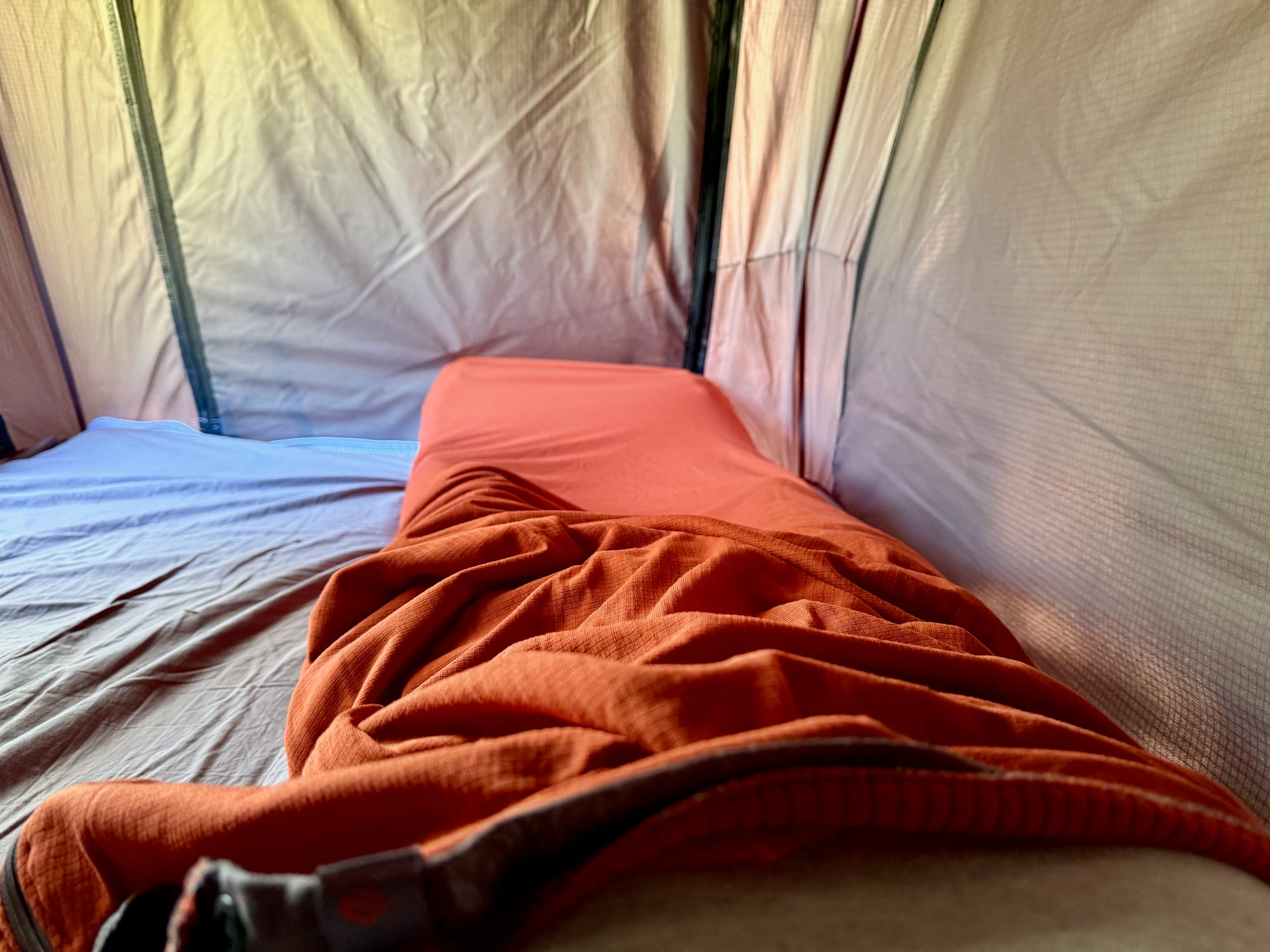 Lying in the Sea to Summit Reactor Fleece liner in our rooftop tent