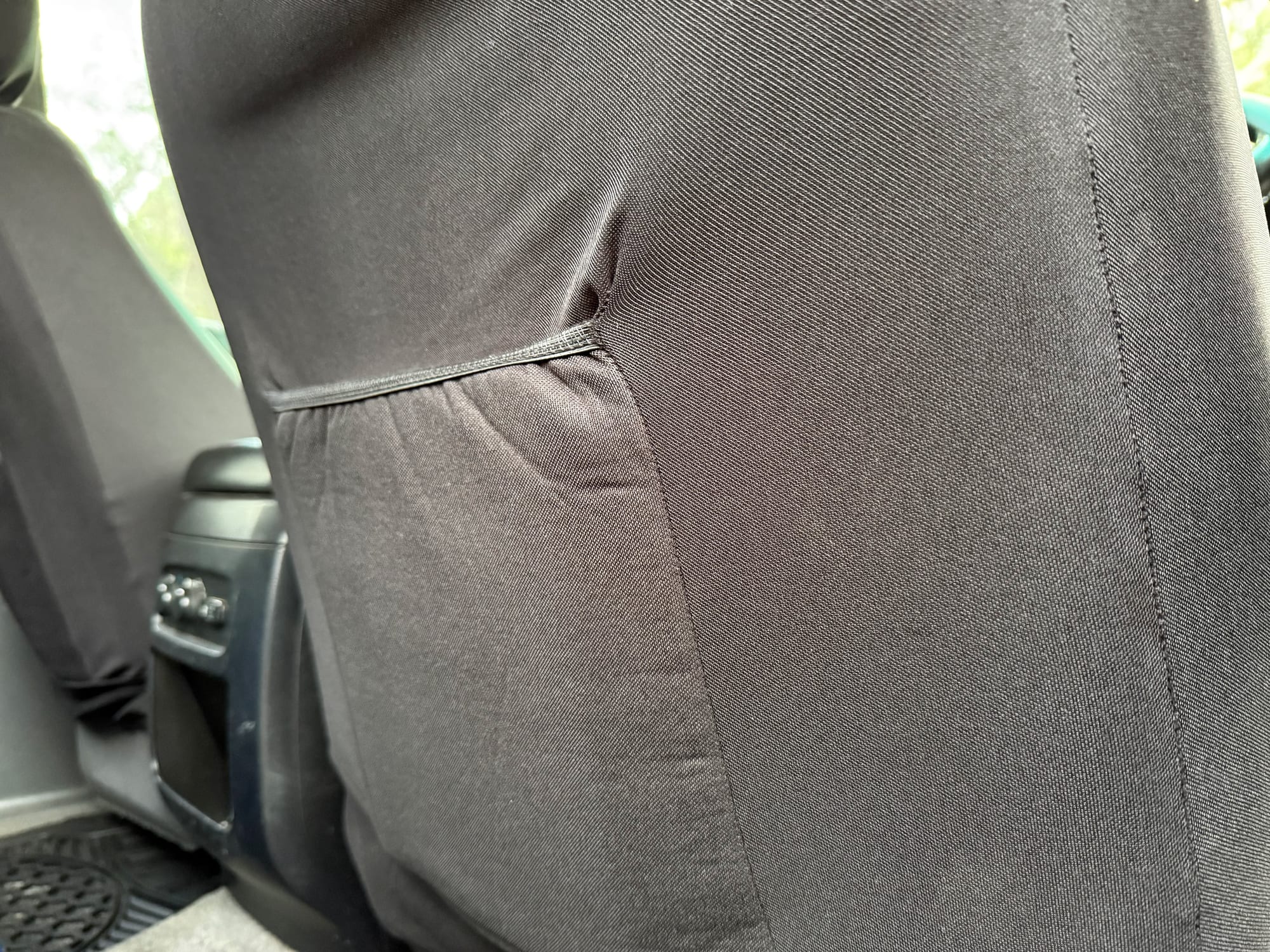The back of the Skechers seat cover over the backrest, with the elastic-topped pocket