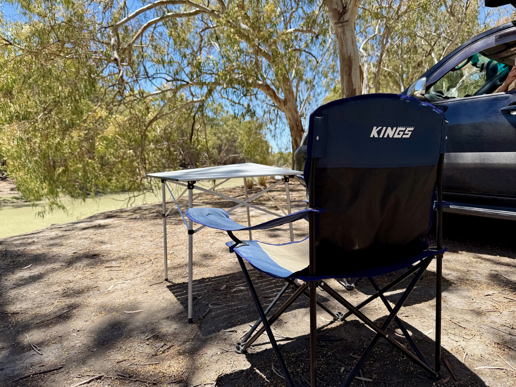 The Spinifex table by a river with two Kings Essential chairs