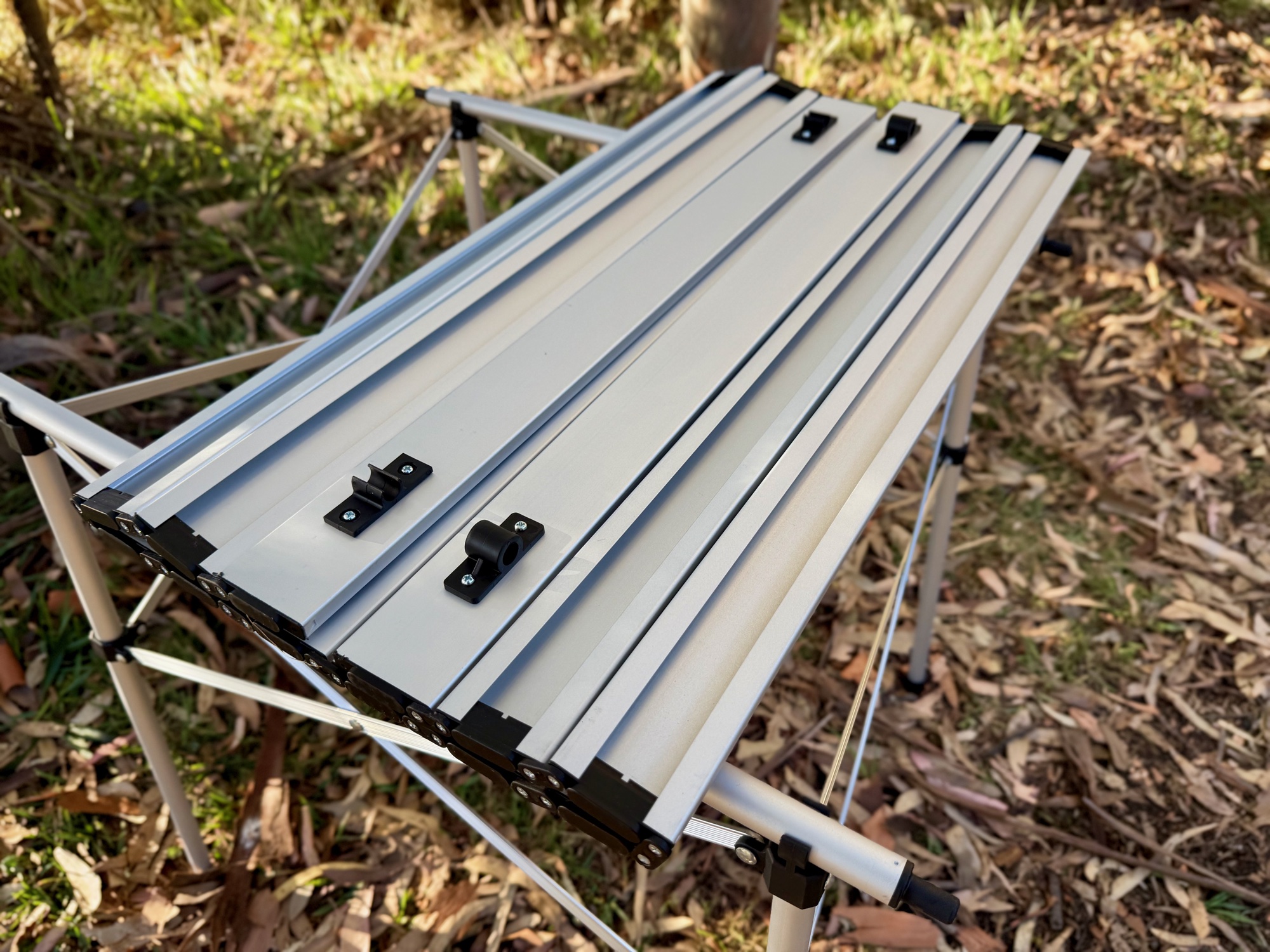 A corner clip holding the slatted top onto the Spinifex table frame